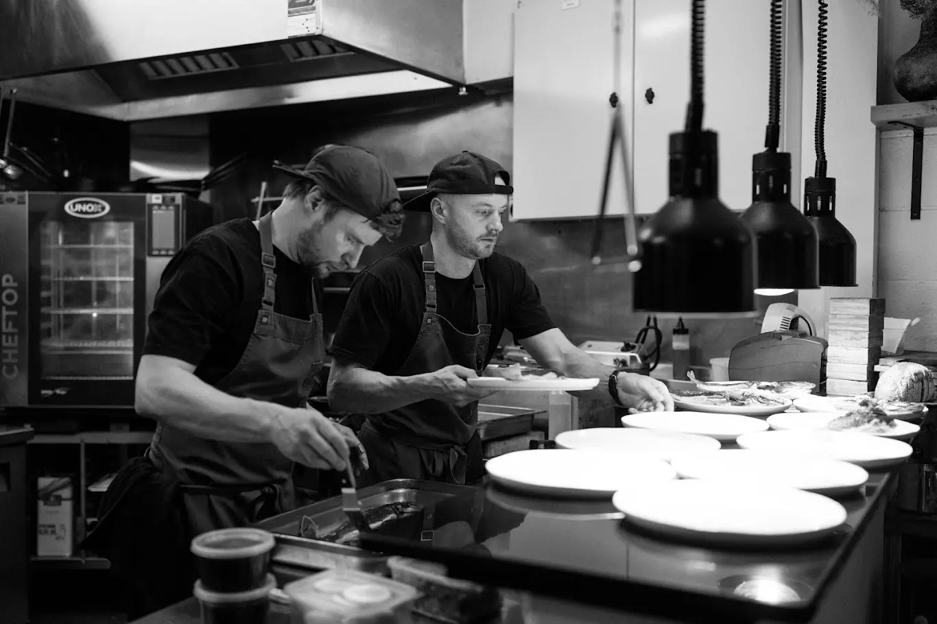 Arc head-chef and co-owner Sam Cooper (left), with his brother, Josh, preparing food at the Ardmore Street Restaurant. Photo: Alpine Image Company
