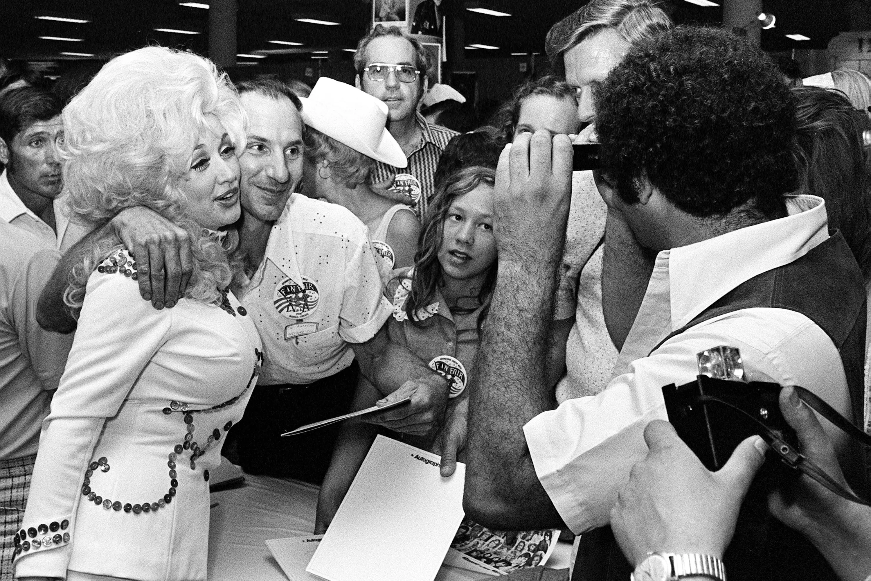 Dolly Parton pauses to pose for a photo, as she signs autographs for fans in her booth at Municipal Auditorium during Fan Fair activities in Nashville, Tennessee, U.S. June 10, 1976.  Dan Loftin/USA Today Network via REUTERS.   \\n\\nNO RESALES. NO ARCHIVES. THIS IMAGE HAS BEEN SUPPLIED BY A THIRD PARTY