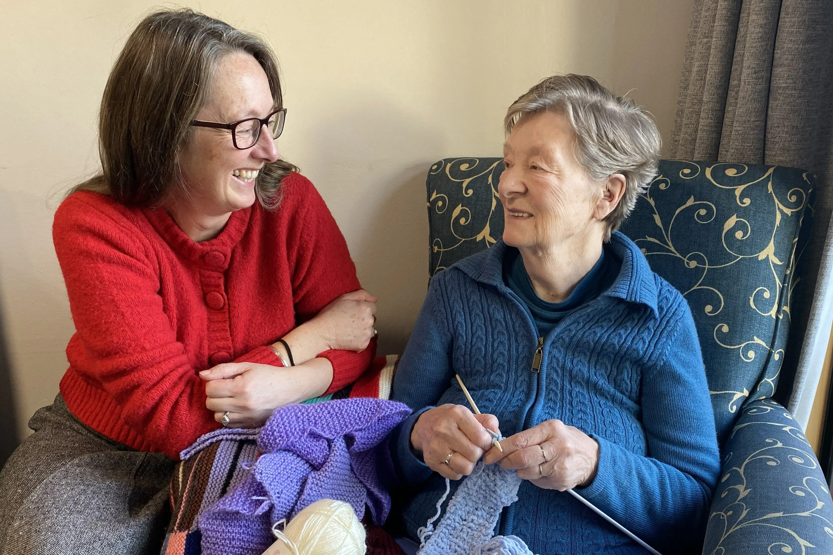 Keen knitter Joan Hodge, right, shares a moment of happiness with her daughter Vanessa Beck, who has curated \"Ravelled\", an exhibition of her knitting, on show now in the White Box display space in the window of Dunedin Fringe Festival HQ. Photo: Brenda Harwood