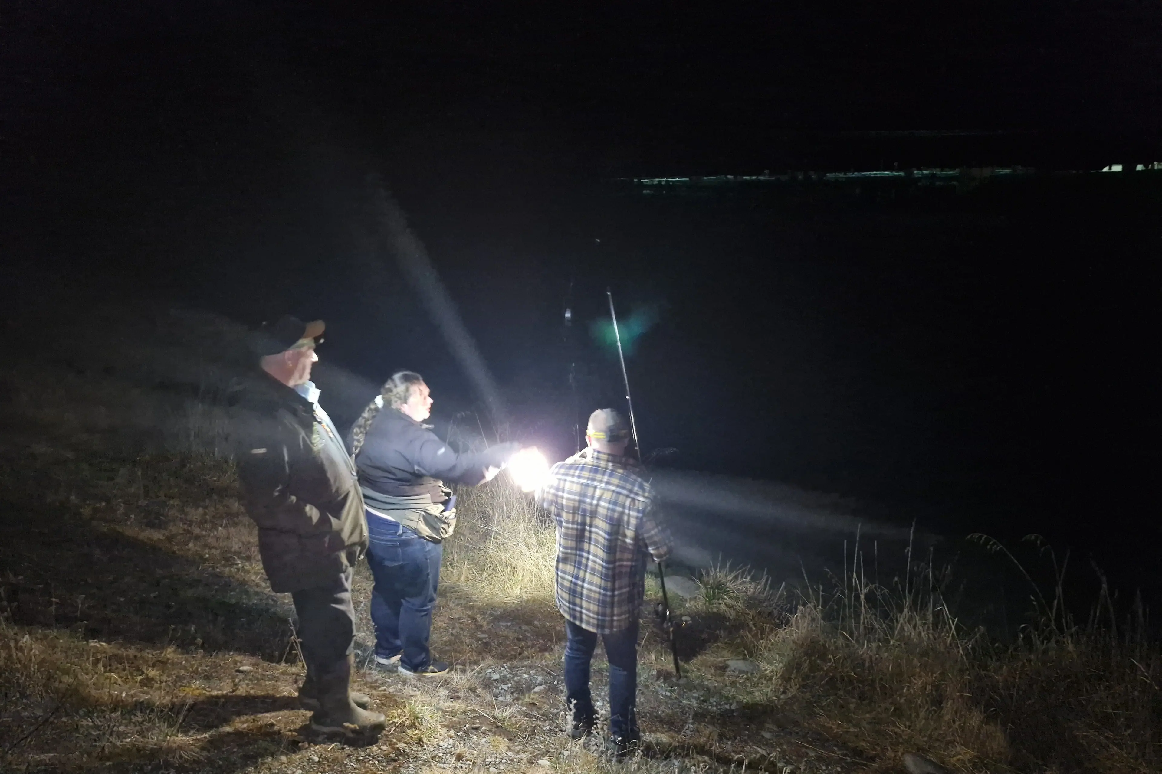 Rangers Nikki Dellway and Brett Cairns check on an angler at night on the Ohau B Canal. Photo: Supplied