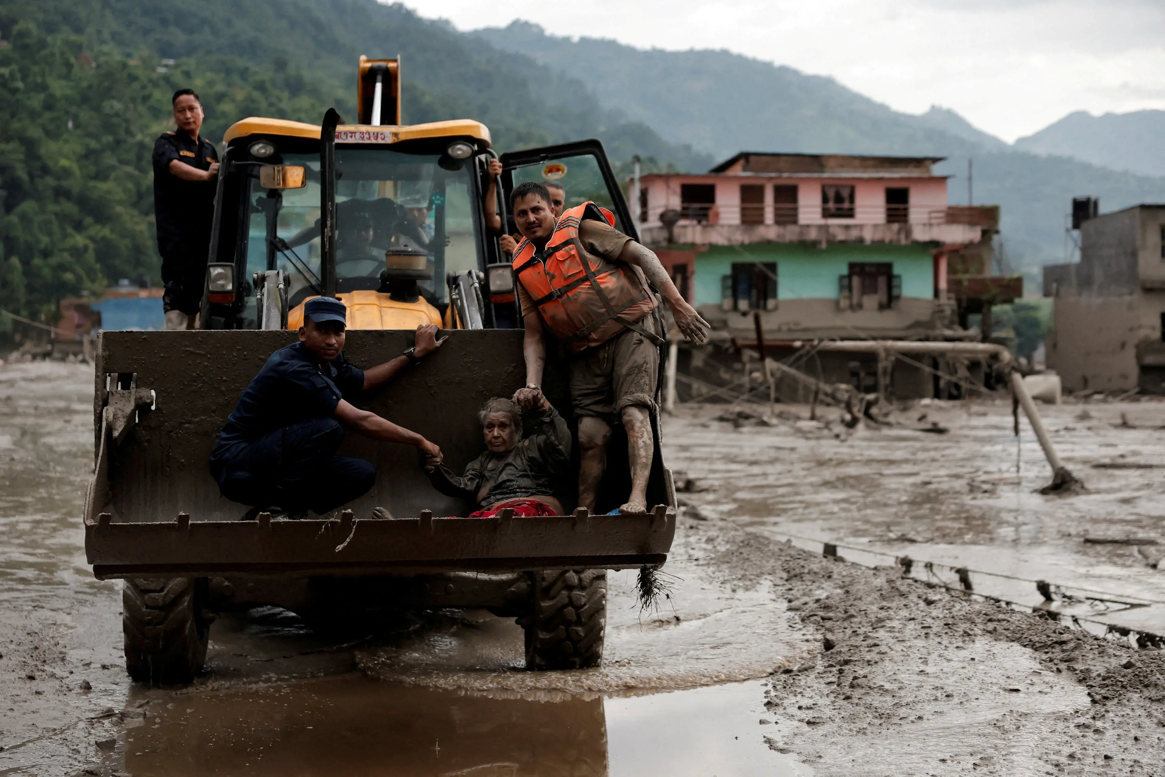 Rescuers are scrambling to save survivors after an avalanche of ice and rock triggered the floods. Photo: Reuters