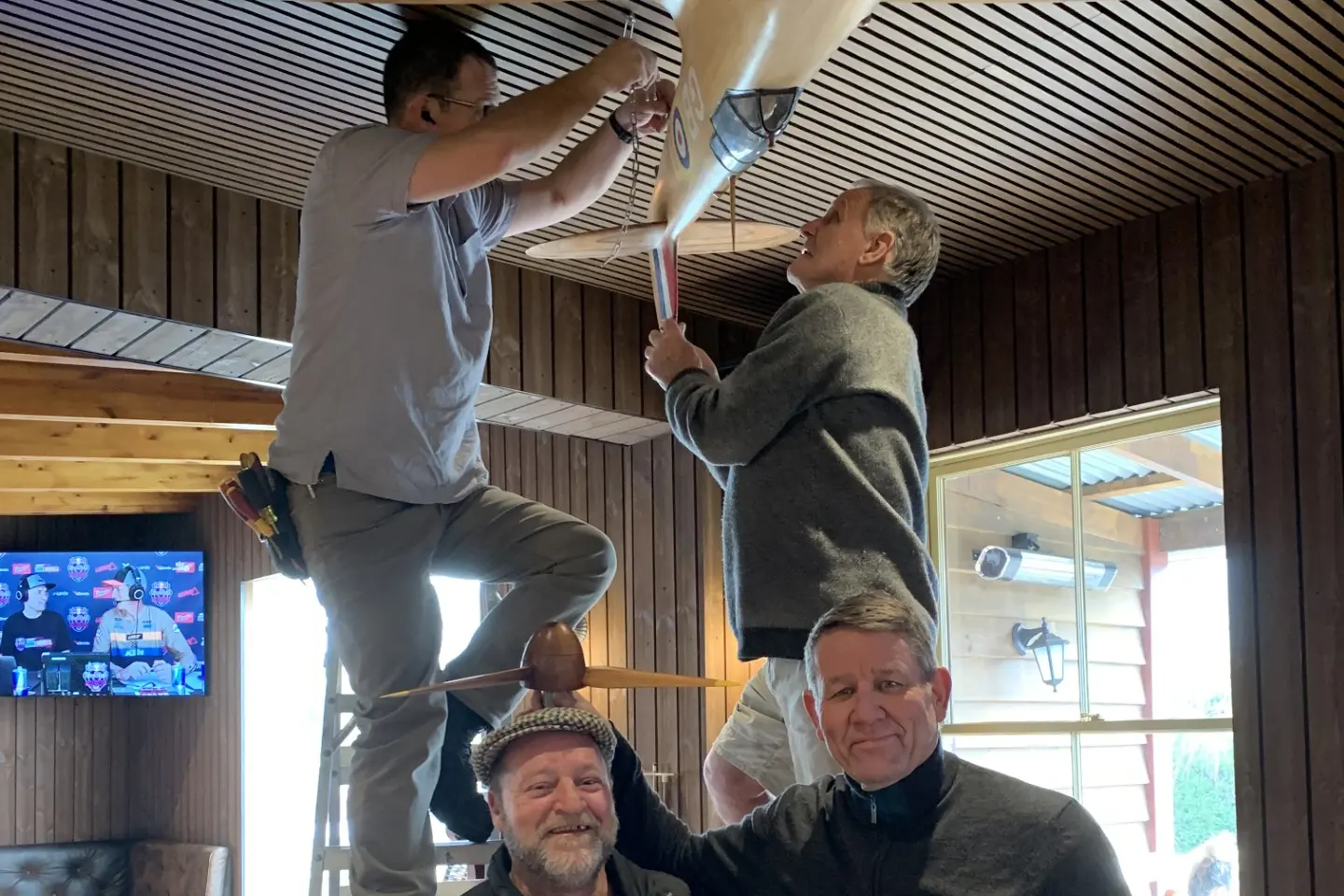 New home for spitfire . . . Back, L-R: Martin Hadfield, Paul Wayman. Front, L-R: Simon Lodge, The Cust Pub publican Phillip Kraal, during the installation of the Spitfire in the Cust Pub.  Photo: Rachel Macdonald