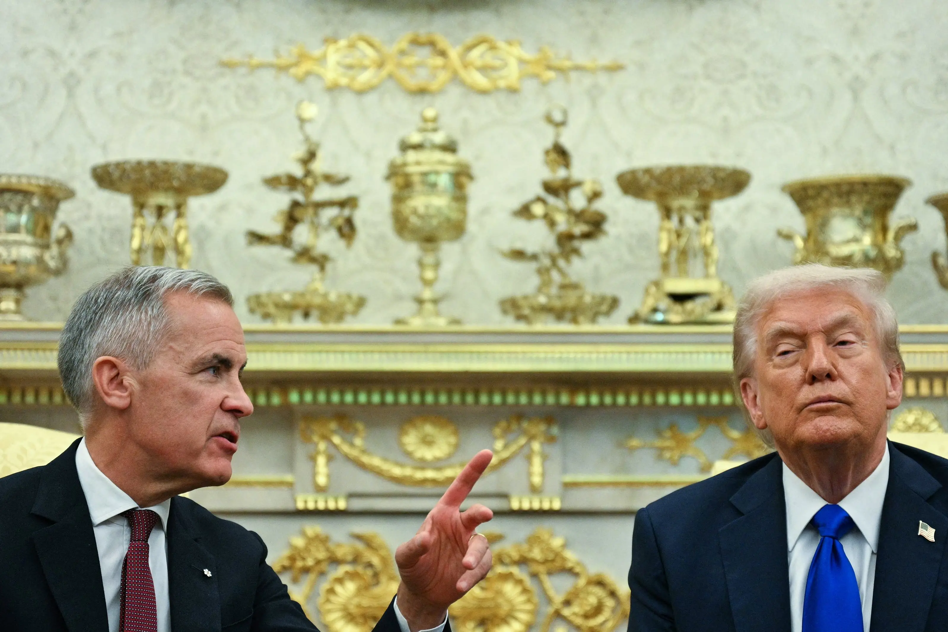 Canadian Prime Minister Mark Carney pointing out what is what to US President Donald Trump in the Oval Office. PHOTO: Getty Images