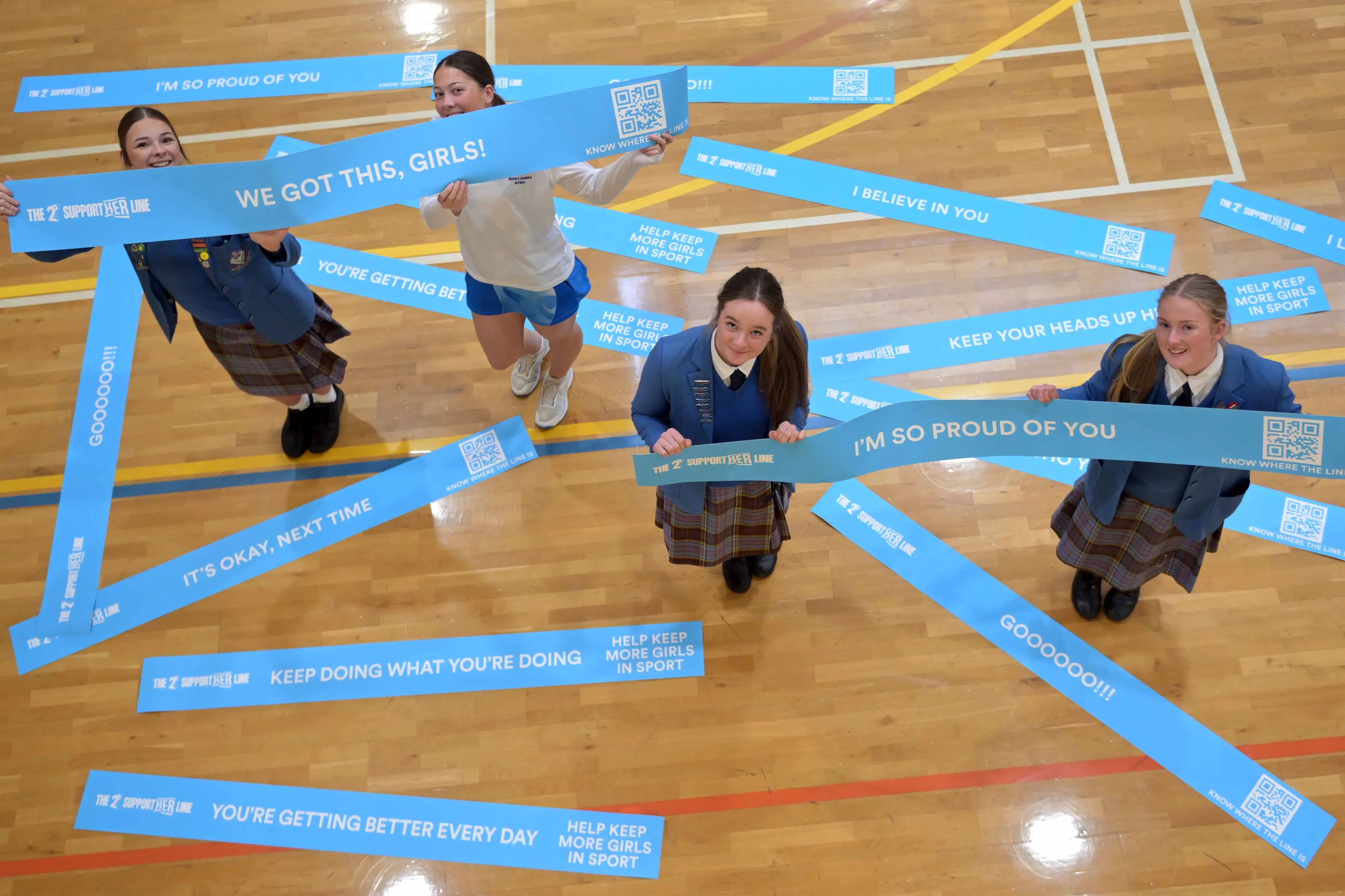 Queen\\'s High School pupils (from left) Brooke Wilson, 16, and Ella Smale, Claudia Haig and Hannah Scott, all 17, with some signs advising what to do on the sporting sideline. Photo: Gerard O\\'Brien