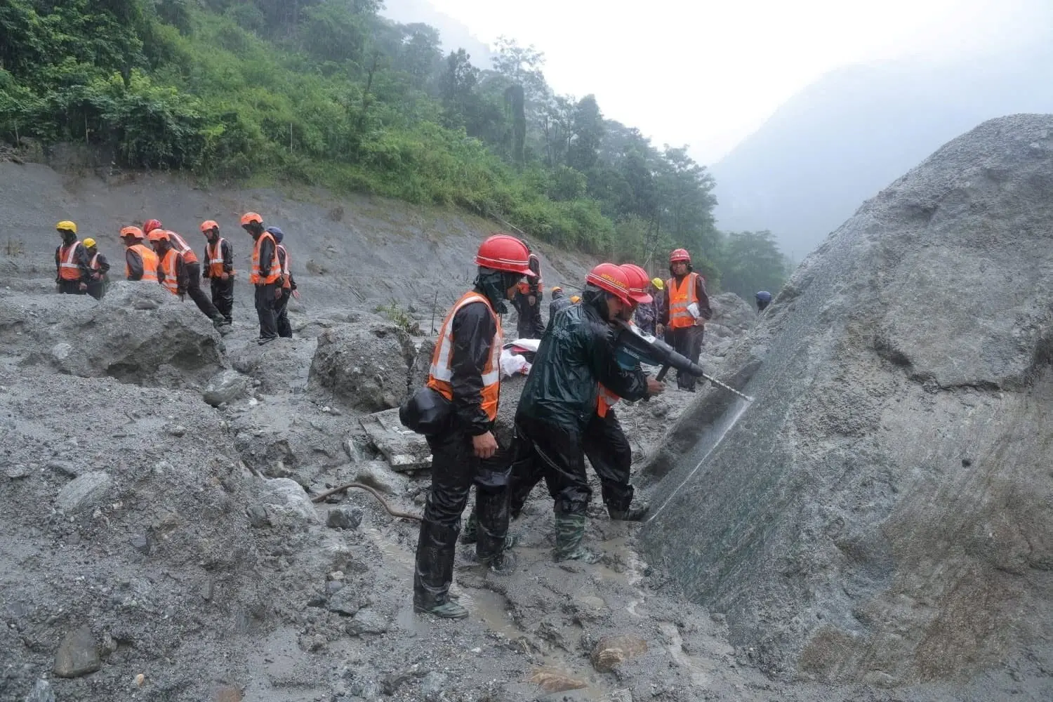 Rescue workers taking part in a rescue operation near the tunnel of the Trishuli 3A Hydropower Project, following deadly flash floods and mudslides, in Rasuwa, Nepal. Photo: Nepal Prime Minister\\'s Office/Handout via Reuters