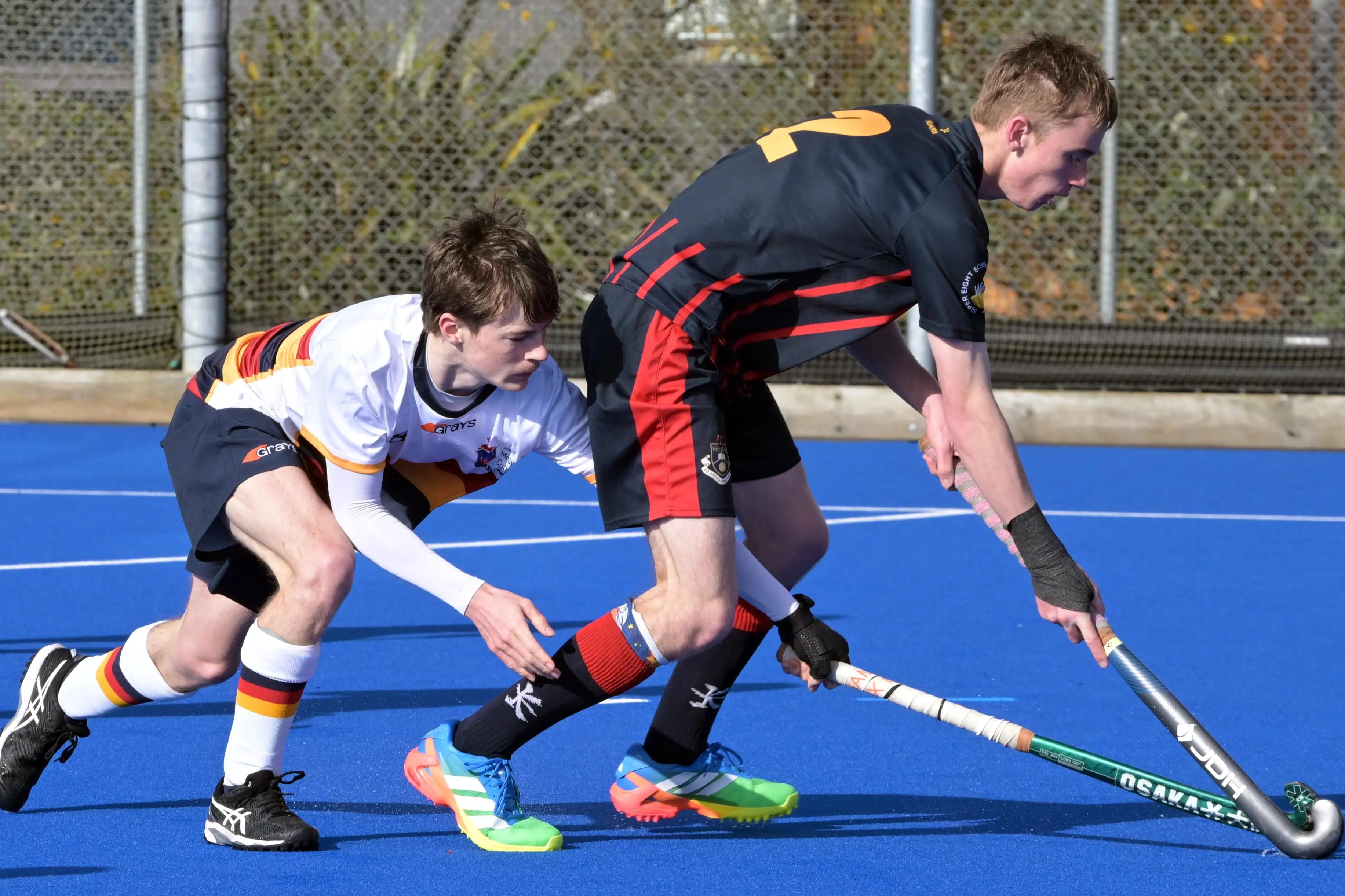 John McGlashan College player Hamish Casey harries Cooper Moulin, of Rotorua Boys\\' High School, during their Rankin Cup and India Shield hockey match at the McMillan Centre in Dunedin on Monday. Photo: Gerard O\\'Brien
