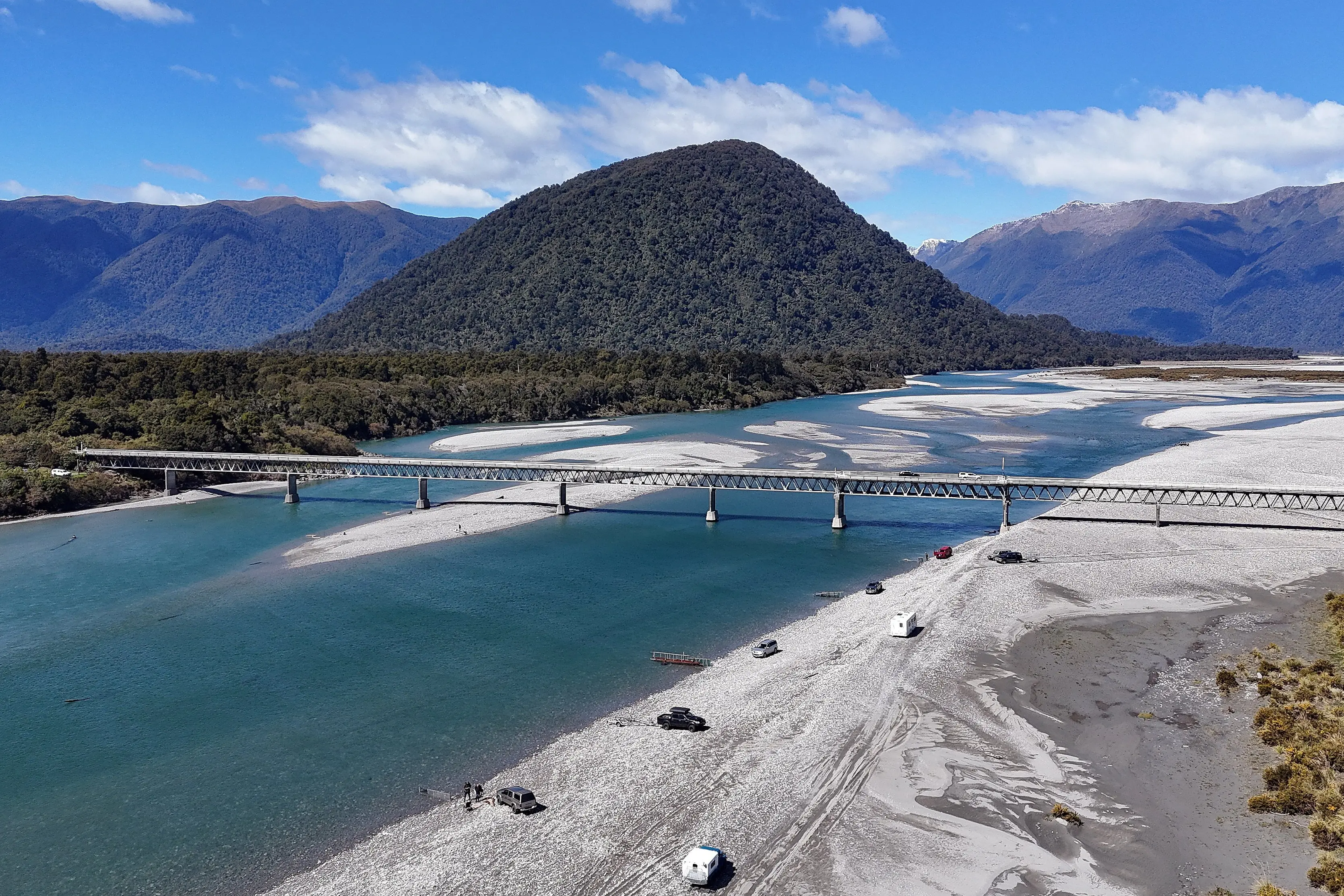 Whitebaiters line the Haast river bank below the Haast bridge hoping to catch whitebait as they migrate up the river to breed. The season runs from 1 September to 30 October. Photo: Stephen Jaquiery