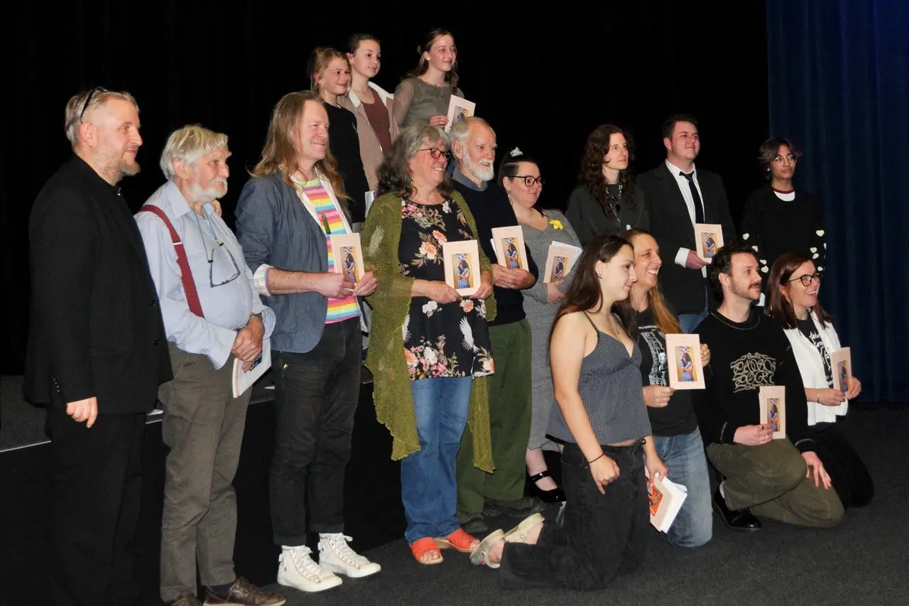 Book launch\\u2026 Oxford poet Doc Drumheller,  the editor and publisher of Fuego, far left, with other poets whose work was published in the latest edition of the World Congress of Poets Literary Journal, during its volume 4 launch  at Rangiora Town Hall Cinemas  on National Poetry Day last Friday. PHOTO: SHELLEY TOPP