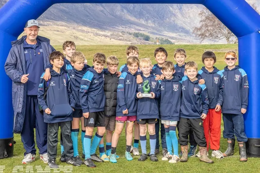 Good sports: Global Games boss Tyrone Campbell, left, after presenting the\\u00A0Wakatipu Lions U11s with the \\u2018Best & Fairest Team\\u2019 award at\\u00A0the NZ\\u00A0Junior Rugby Festival last weekend. Photo: Global Games
