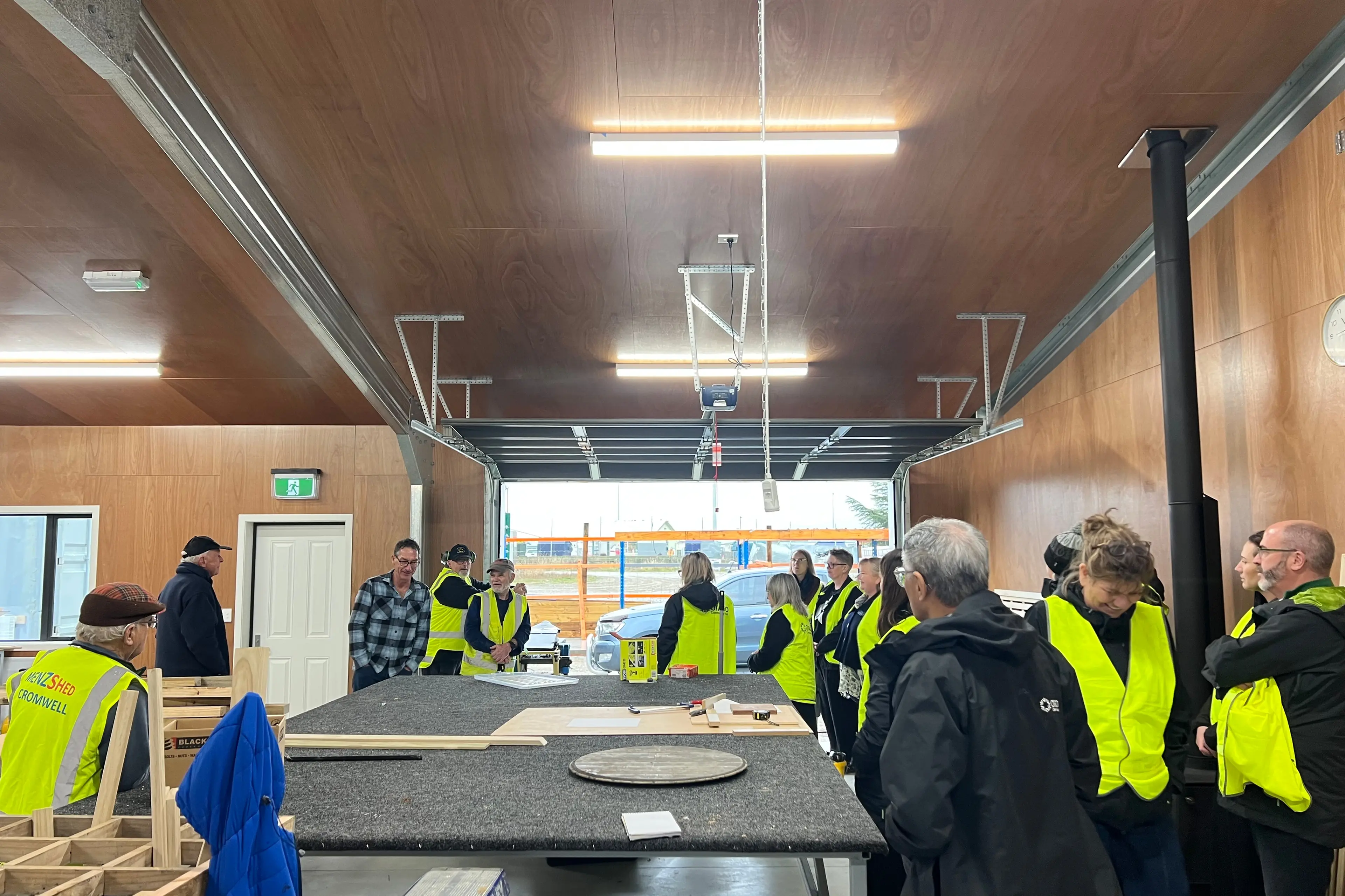 Otago Community Trust trustees and board members with Cromwell Menzshed members, touring the multi-purpose Menzshed building and seeing first hand where funding goes. Photo: Carys Trotter