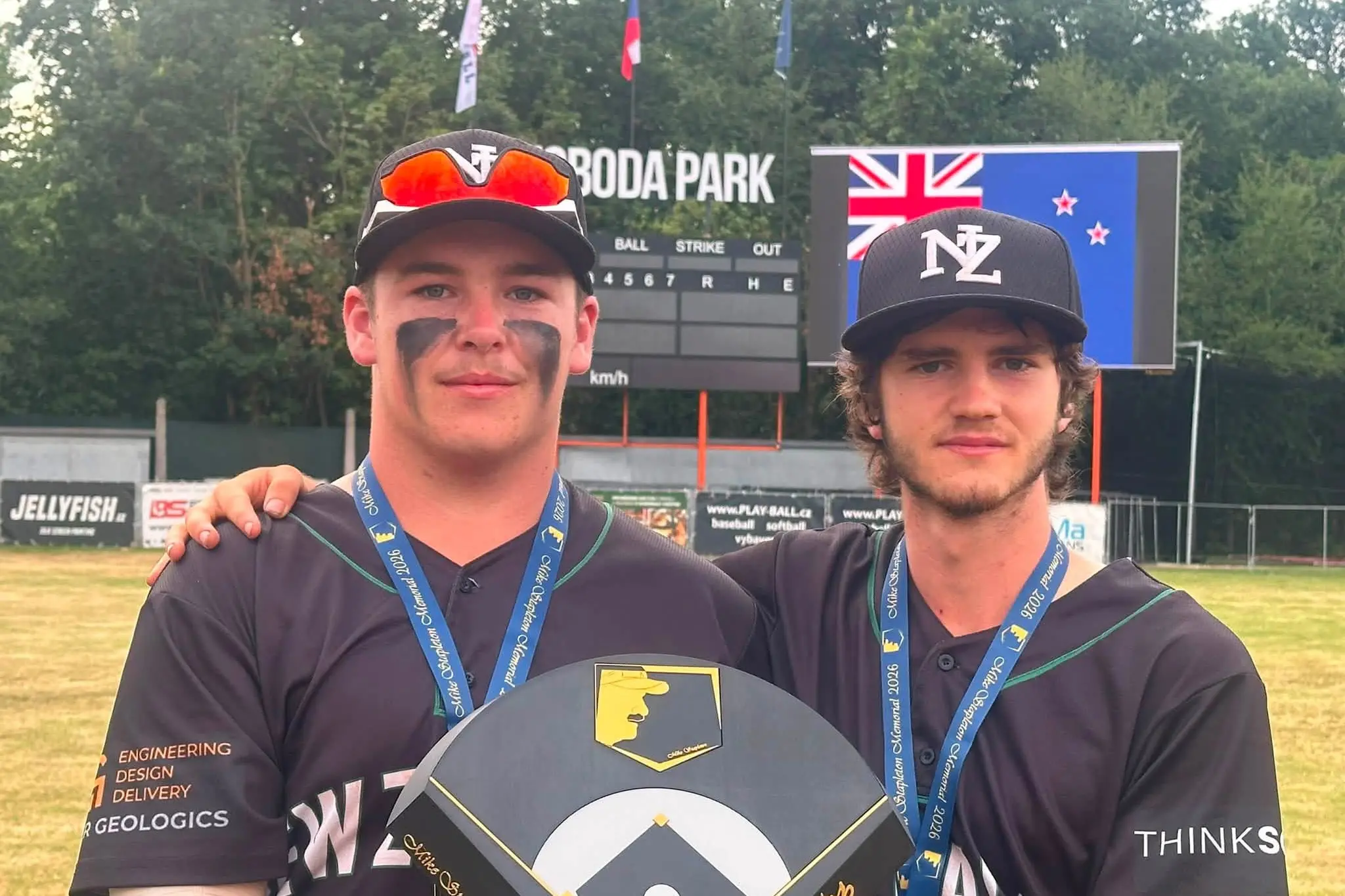 Playing for NZ ISA U19 Boys, local softball players Lachie Cater (left) and Anthony Baker show off their gold medals and the Mike Stapleton Memorial trophy after winning the tournament in Prague. Photo: Supplied