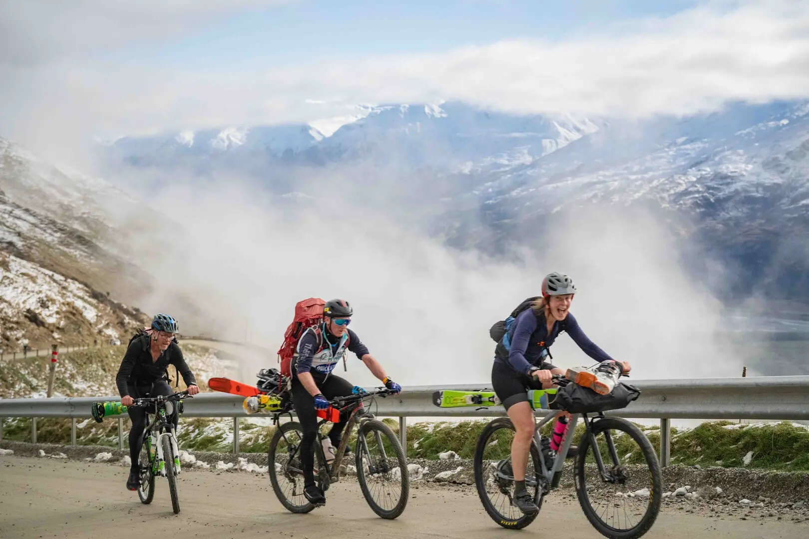 Green Steam participants ride up the Treble Cone access road with ski gear strapped to their bikes. Photo: Christopher Chase