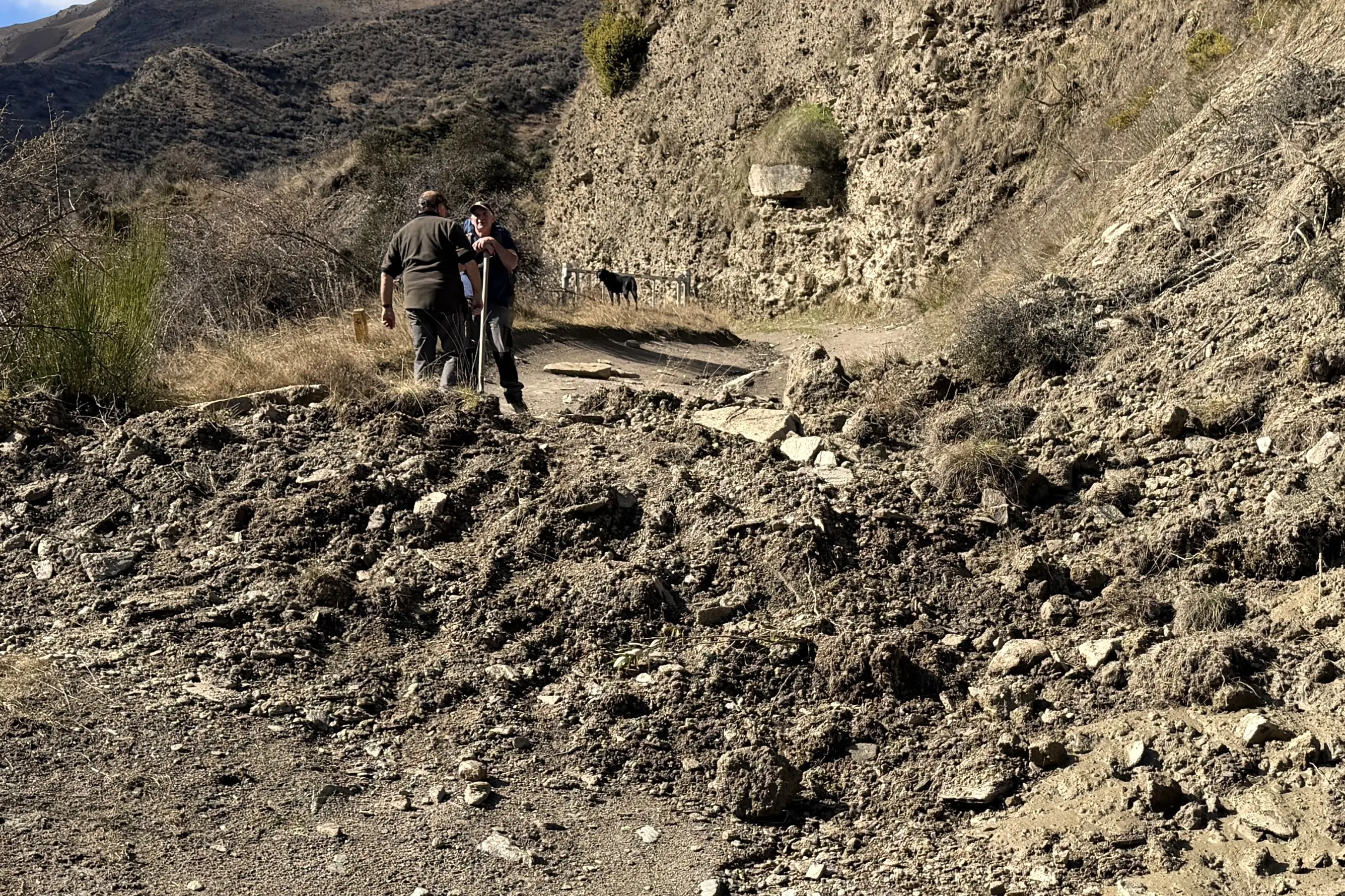 Storm damage: Shotover 4WD Club members inspect a slip on the Macetown Road on Tuesday. Photo: Kevin Barlow