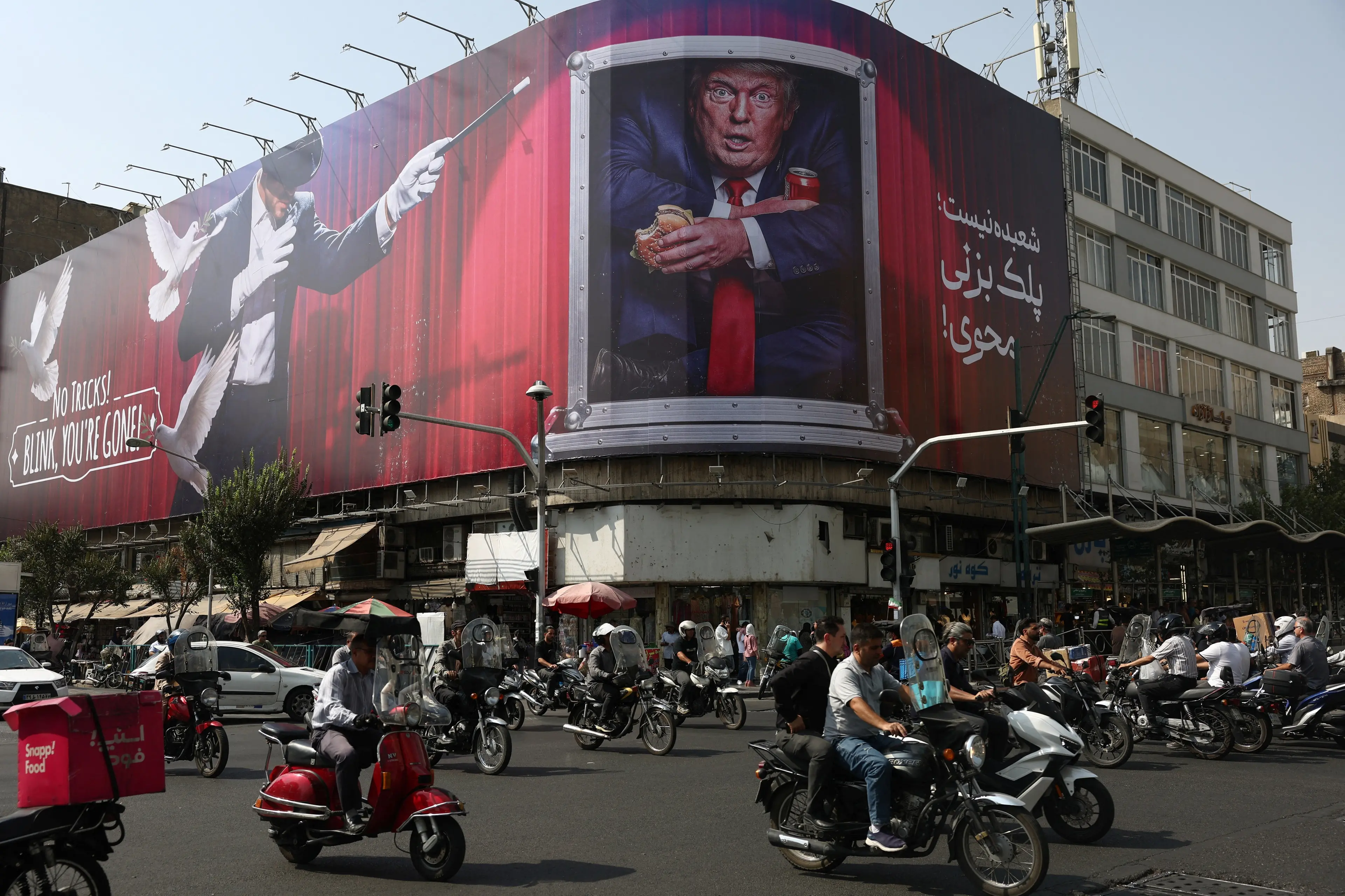 <p>People drive near a billboard depicting US President Donald Trump on a building in Tehran, Iran. Photo: Majid Asgaripour/WANA (West Asia News Agency) via REUTERS</p>\\n