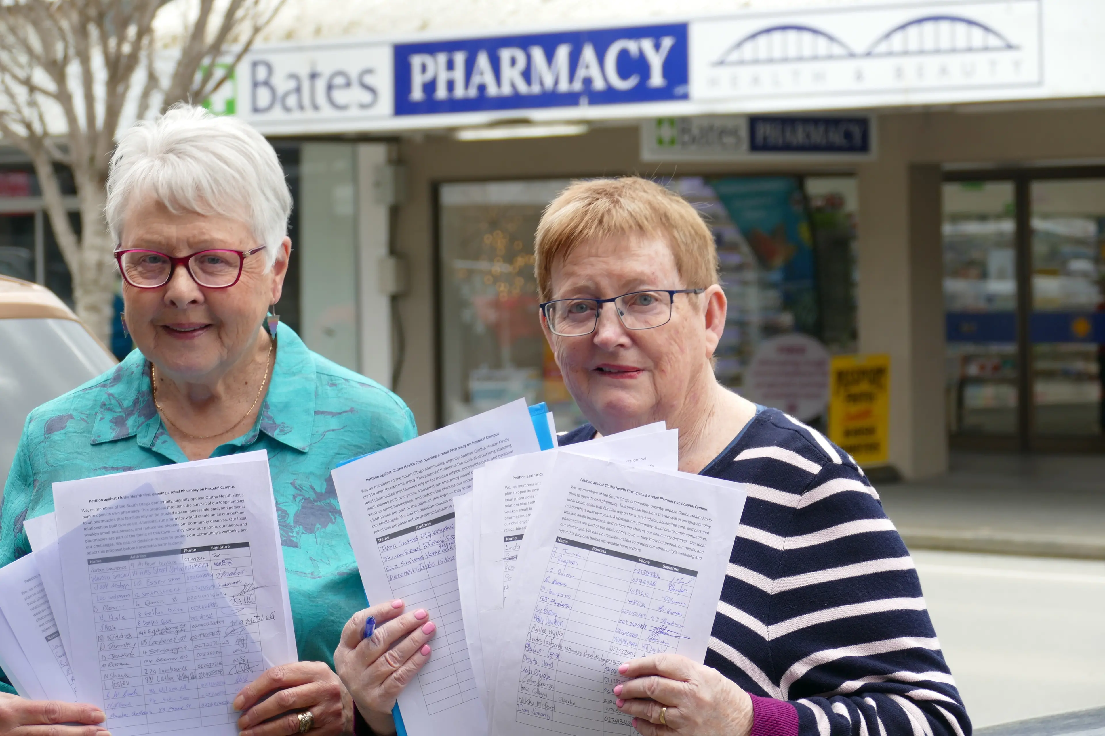 Balclutha retirees Barbara Thomson, left, and Nancy Corkery display some of the 400-plus signatures they have garnered for a petition to save the town\\'s two pharmacies from what they say is unnecessary fresh competition. Photo: Richard Davison