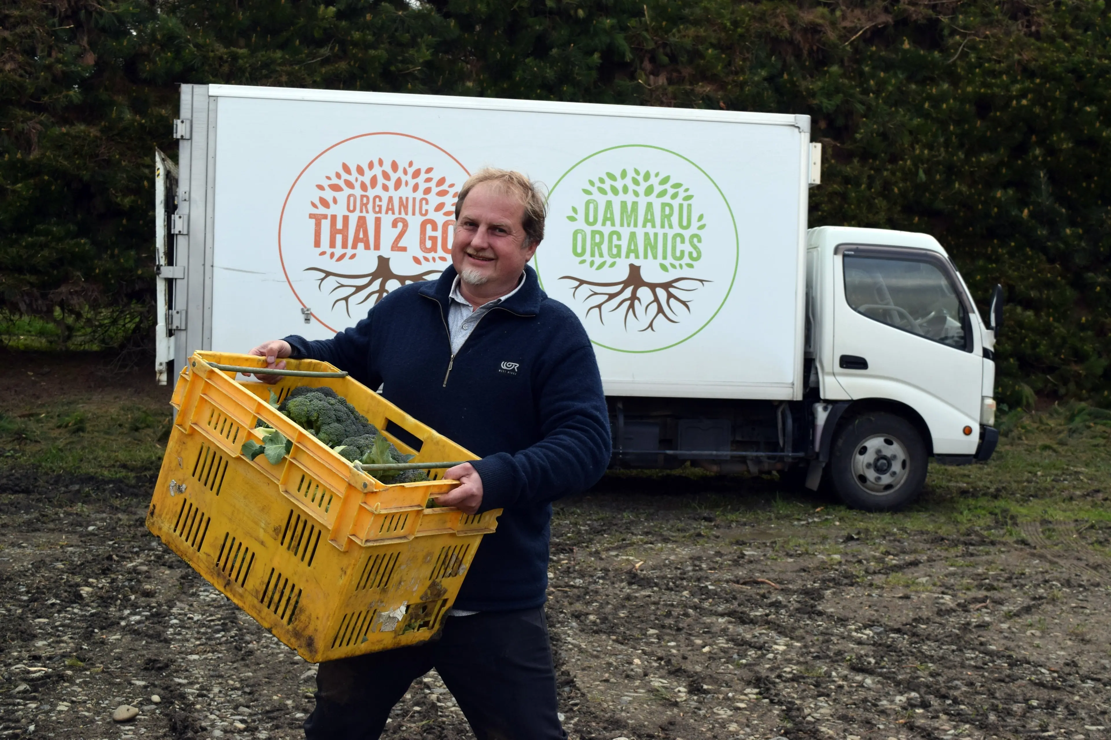 Organic Solutions director and co-founder James Porteous packing a truck with organic vegetables. Photo: Shawn McAvinue
