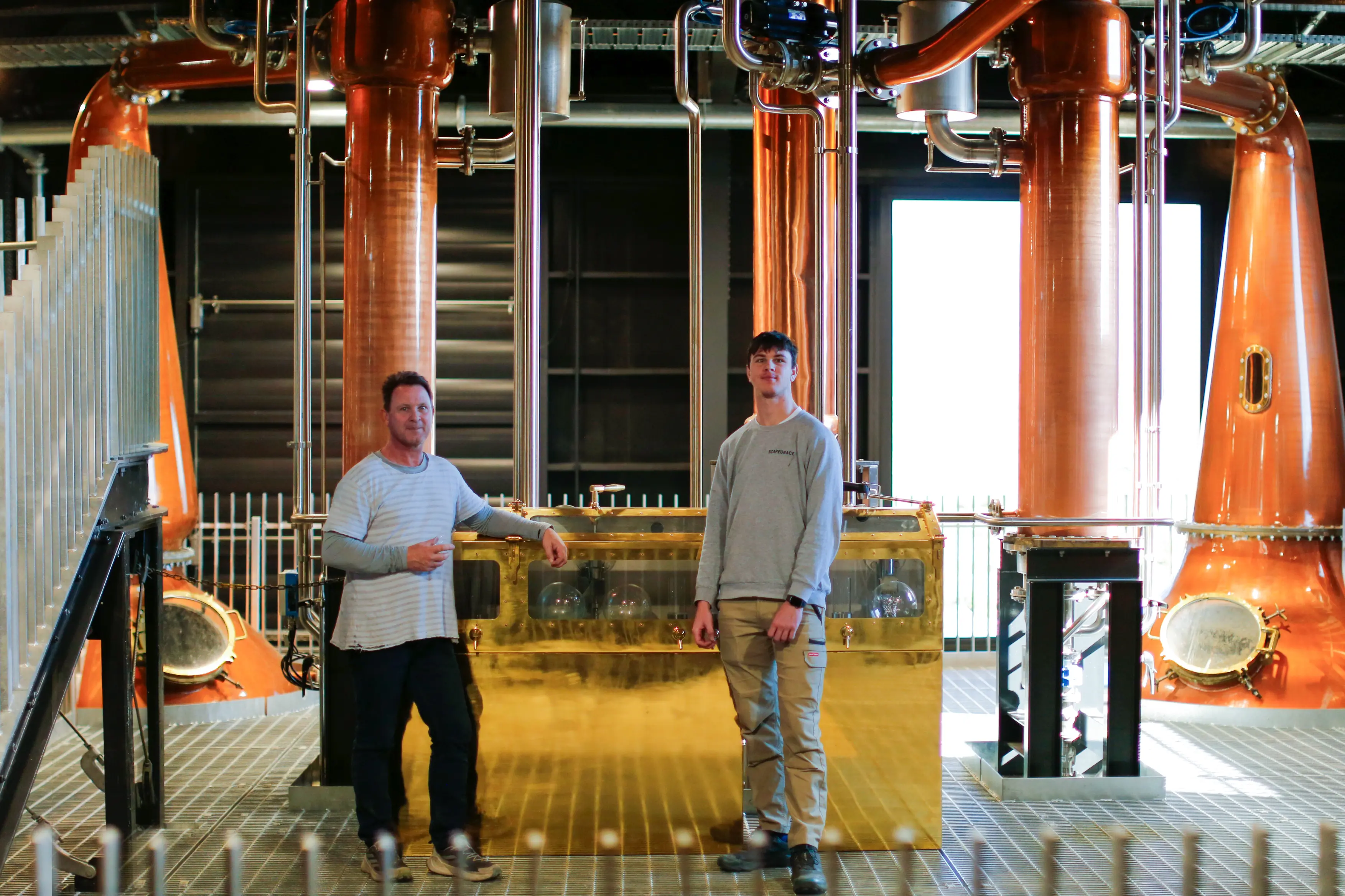 Anthony (left) and son George Lawry, who both work at Scapegrace Distillery, are second- and third-generation whisky distillers. Photo: Supplied