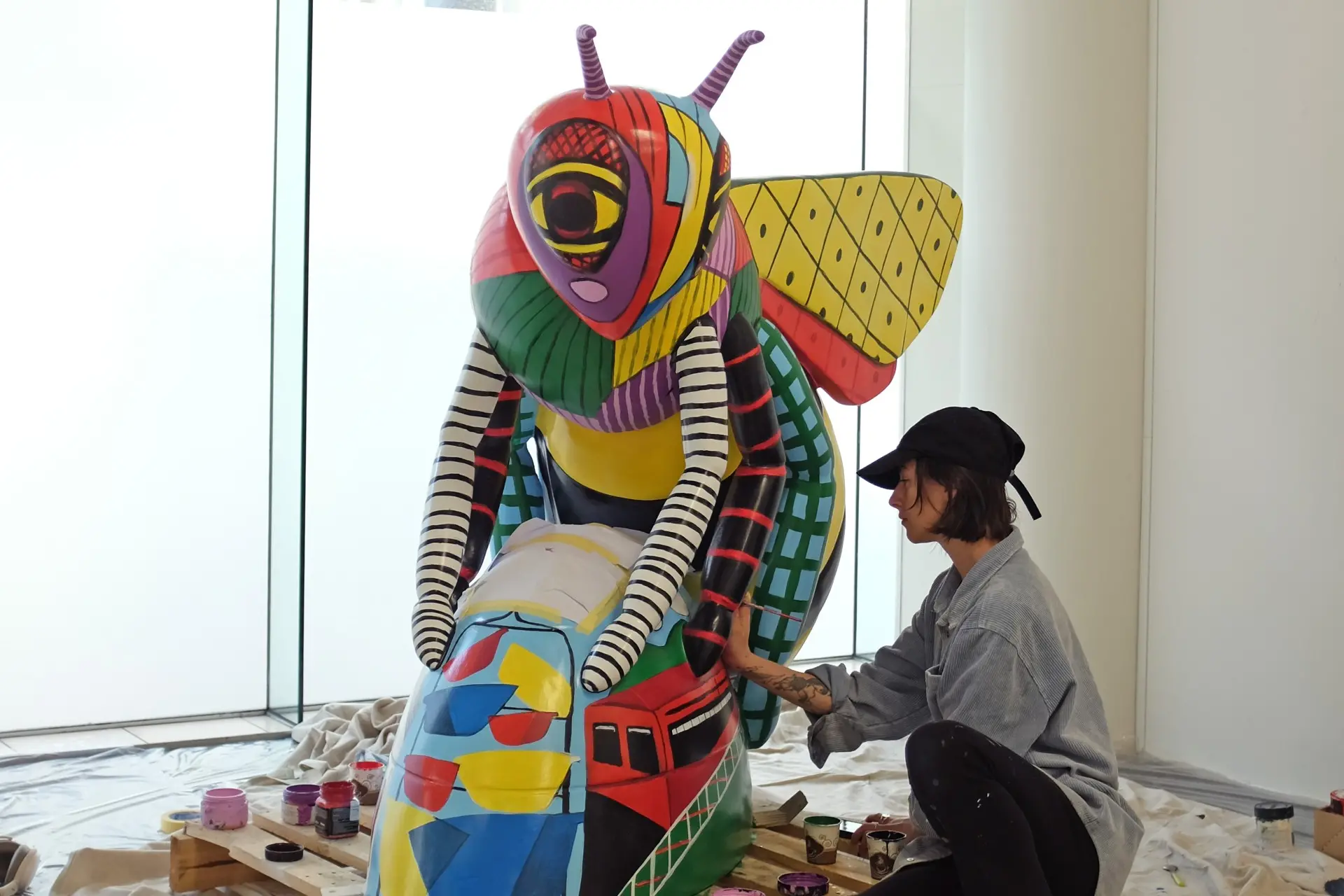 Dunedin artist Lily Warring works on painting her fibreglass bee which is due to be displayed at the Wellington Railway Station later this month. Photo: Supplied