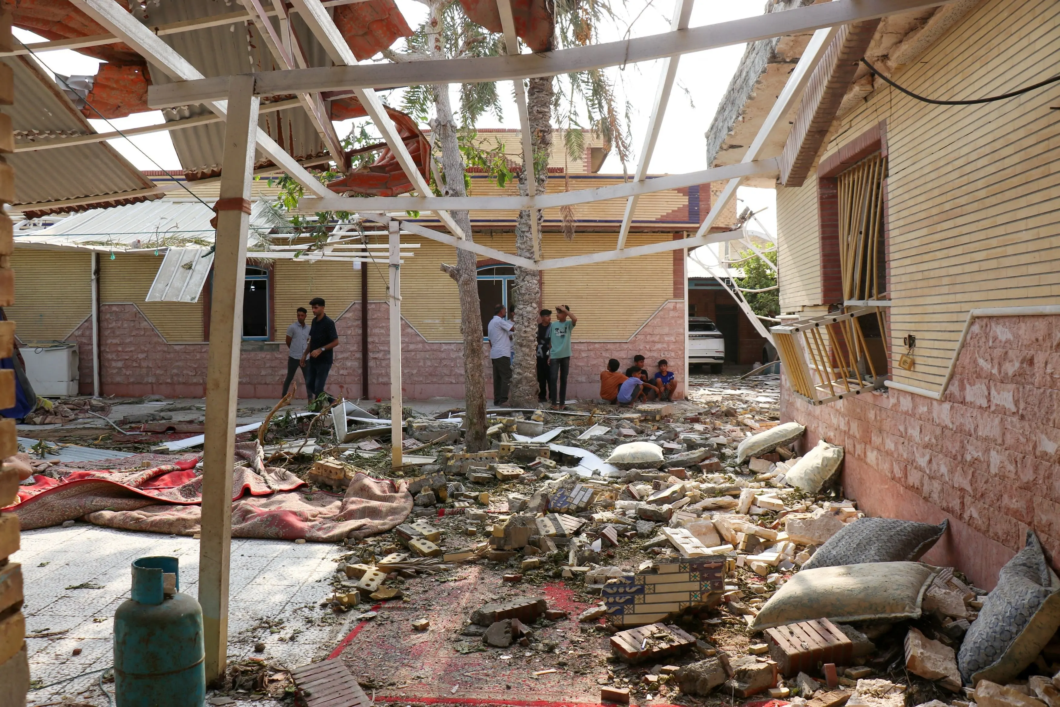 A war going nowhere fast: rubble lies around damaged houses following a reported attack near a wedding gathering in Kuhistik, Sirik, Iran. Photo: via Reuters