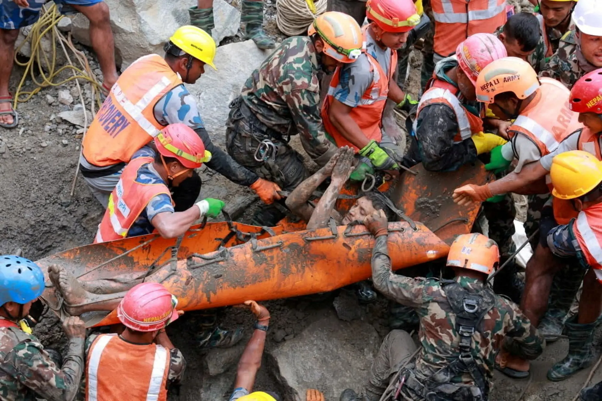 Survivor Kabir Maharjan is carried by members of a search and rescue team. Photo: Nep