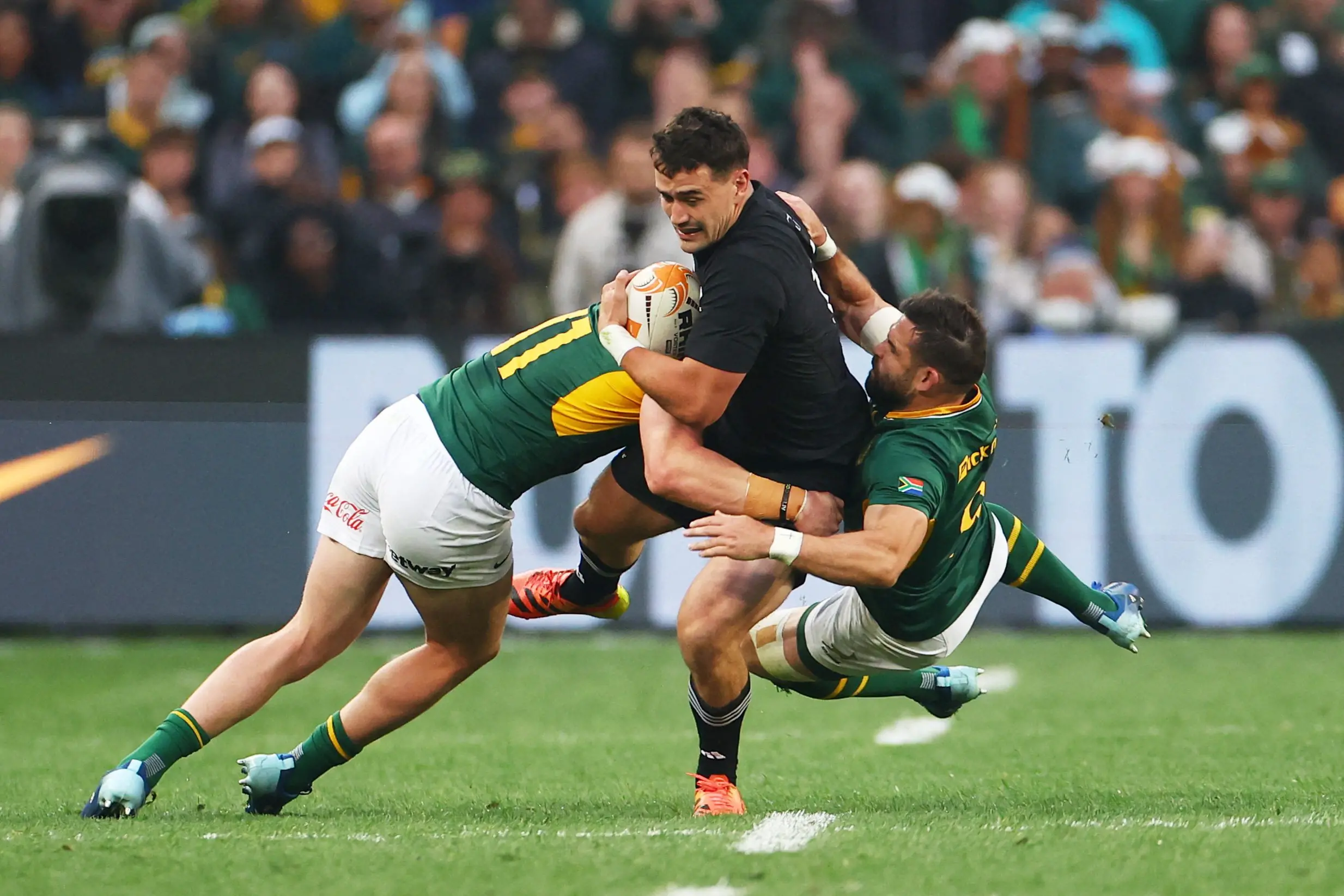 All Blacks winger WIll Jordan is tackled by South African defenders Ethan Hooker (left) and Cobus Reinach during the third Greatest Rivalry test at FNB Stadium in Johannesburg. Photo: Reuters