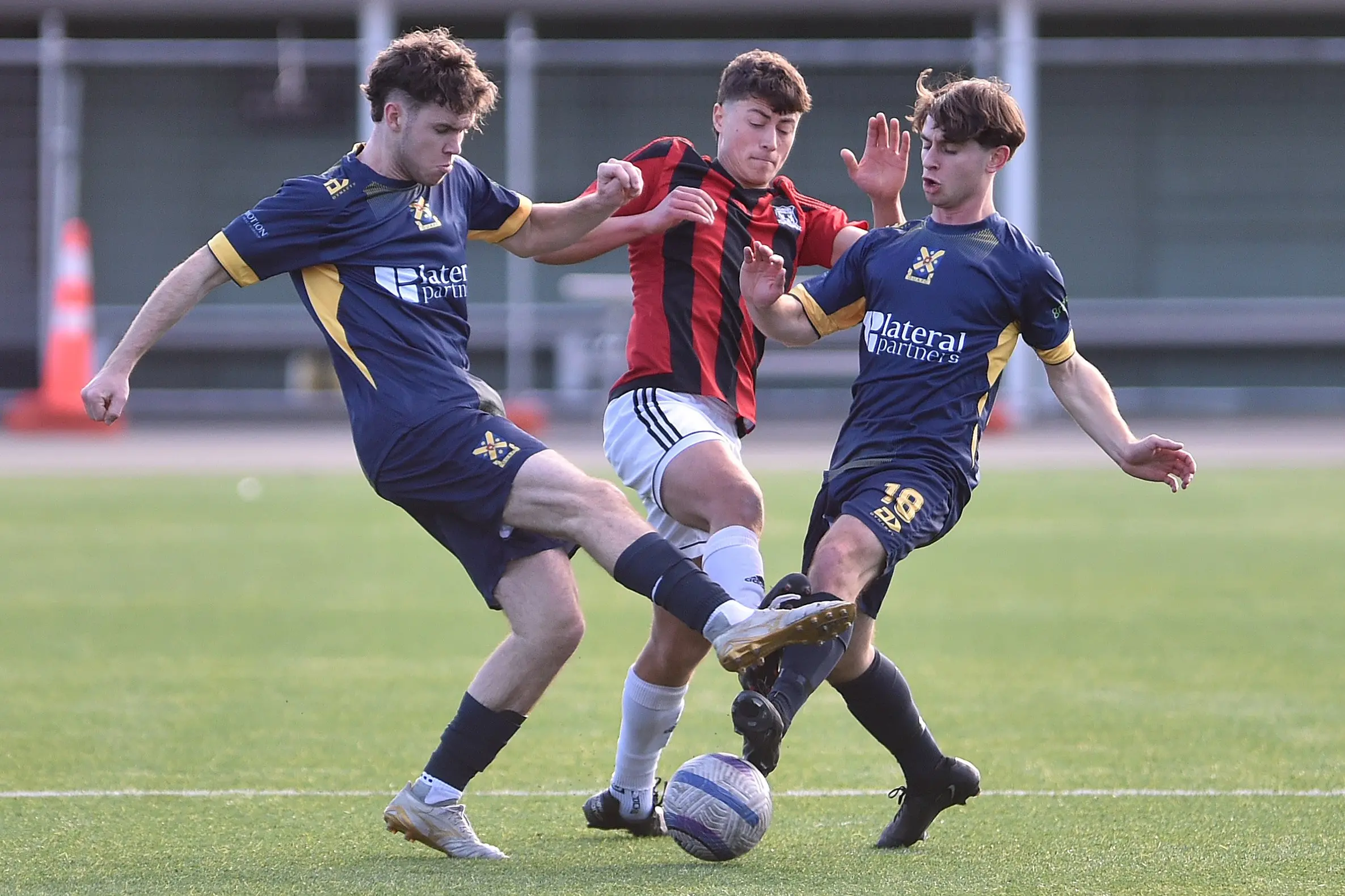 Mosgiel midfielder Jaxon Maze (centre) tries to find a path through Otago University defenders Patrick Tyrell (left) and Dominic Hawkins at the Logan Park turf on Saturday. Photo: Gregor Richardson