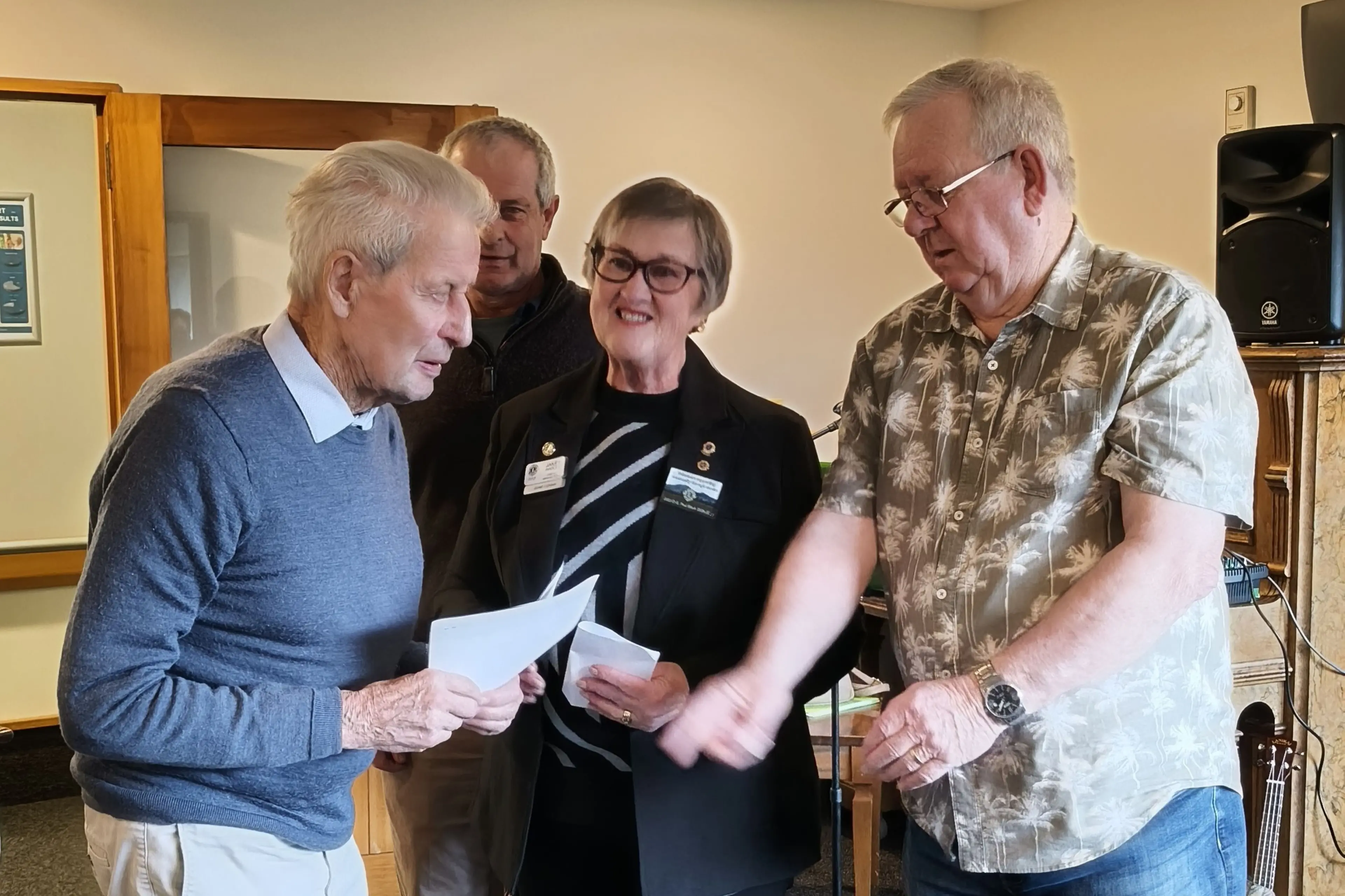 Ashburton Pakeke Lion Murray Faulkner (left) receives his 55 year chevron from president Neil Gibbs watched by Zone I chair Janet Hadley. Photo: Supplied