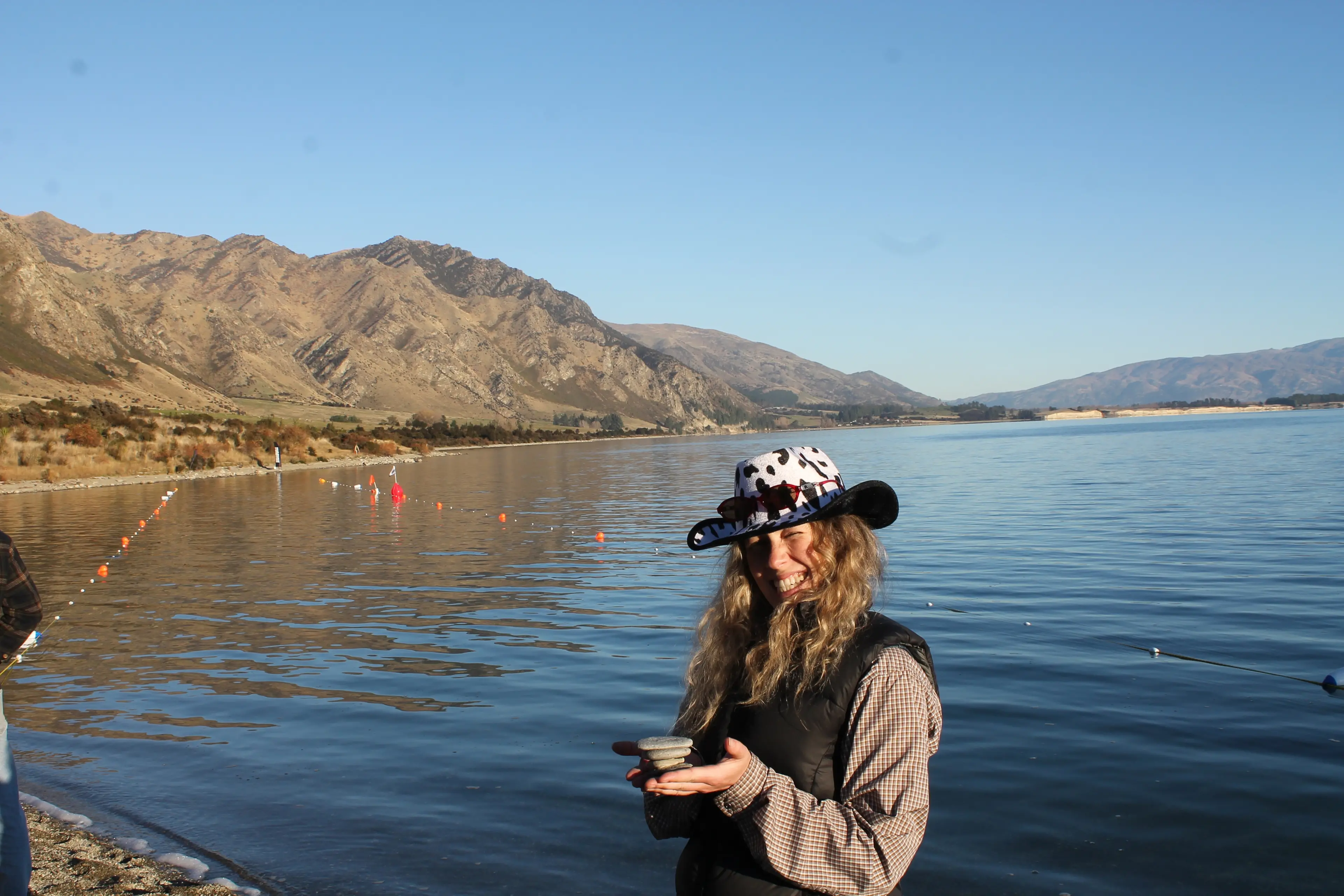 Stone skimming world champion Abbey McDonald poses with stones assembled before the final of the Aotearoa Stone Skimming Championships in May. Photo: Ruairi O\\'Shea