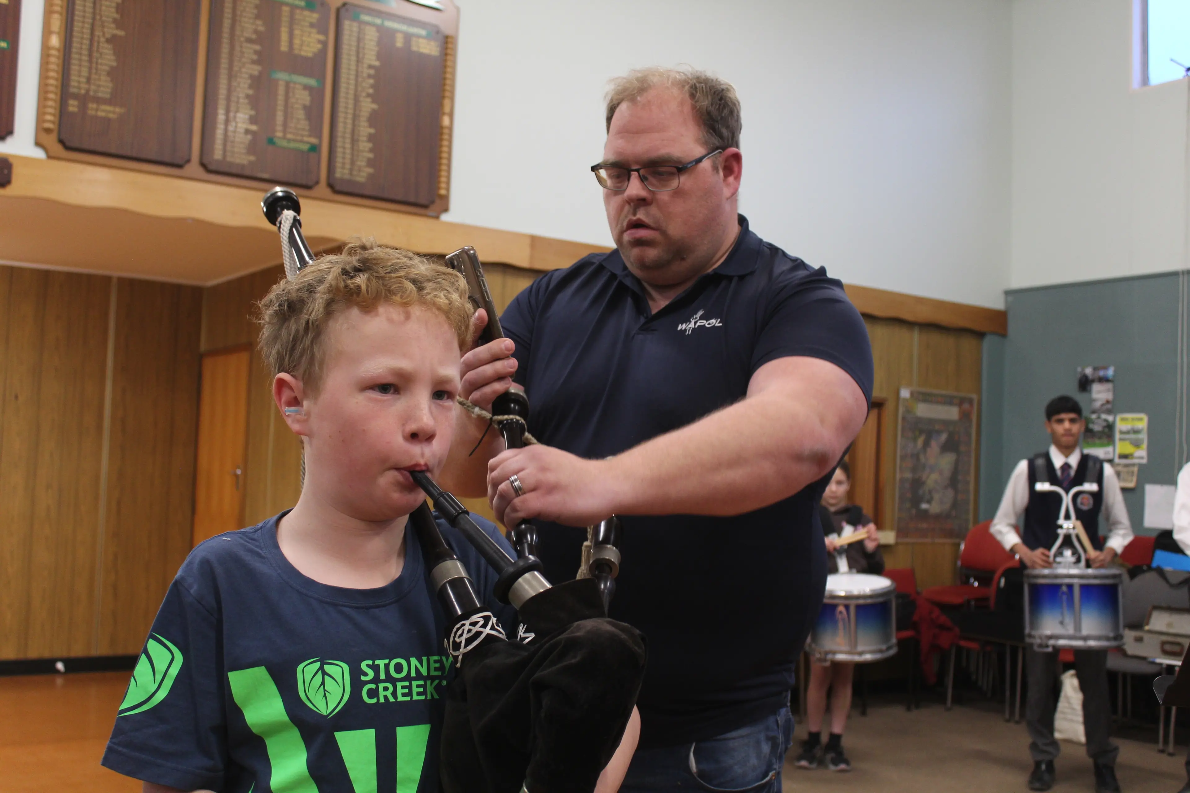 Pipe major Alasdair Mackenzie tuning Angus McRae\\'s bagpipes. Photo: Tayler Mutton