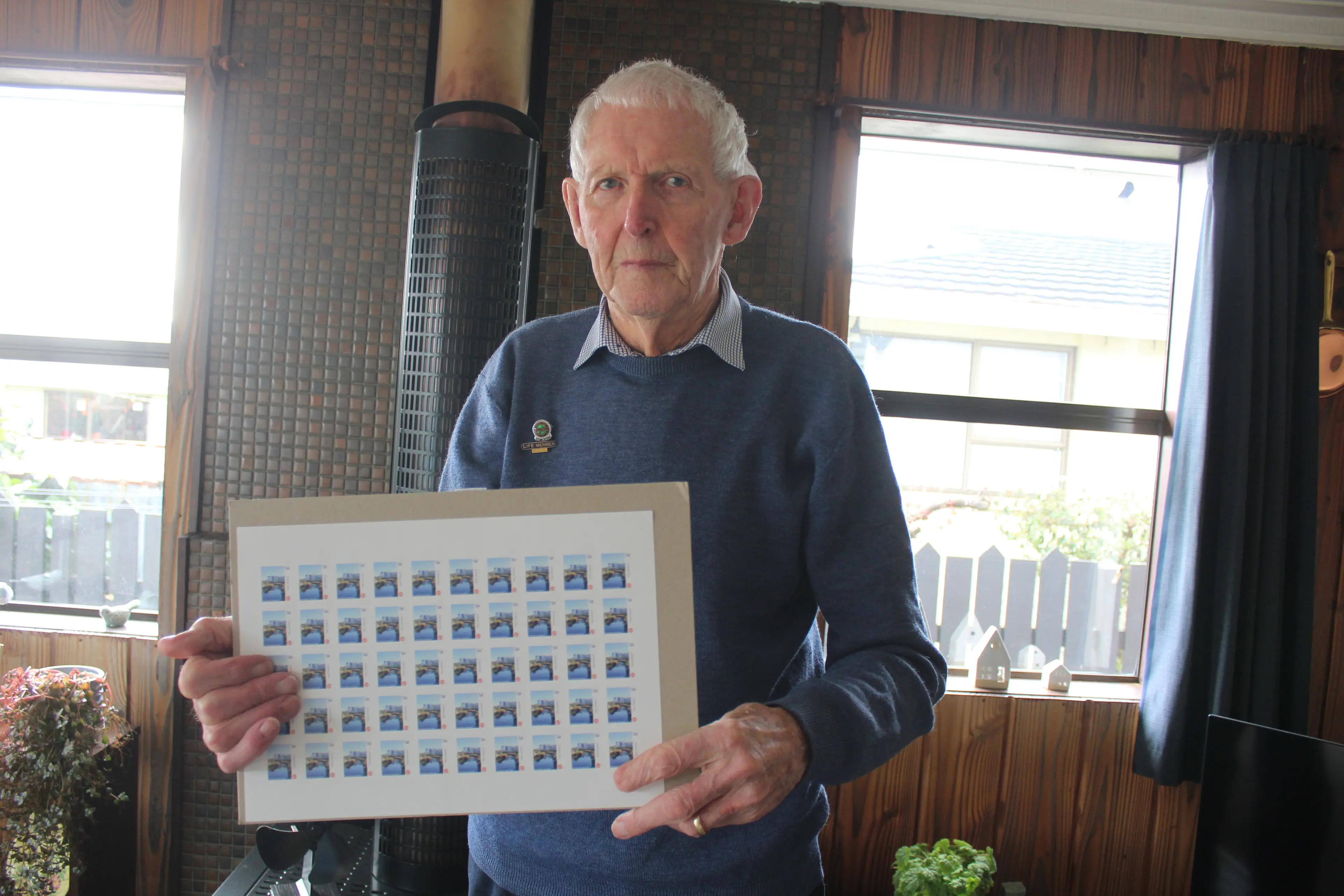 Ritchie Dick holding the new Invercargill NZ Post stamps. Photo: Tayler Mutton
