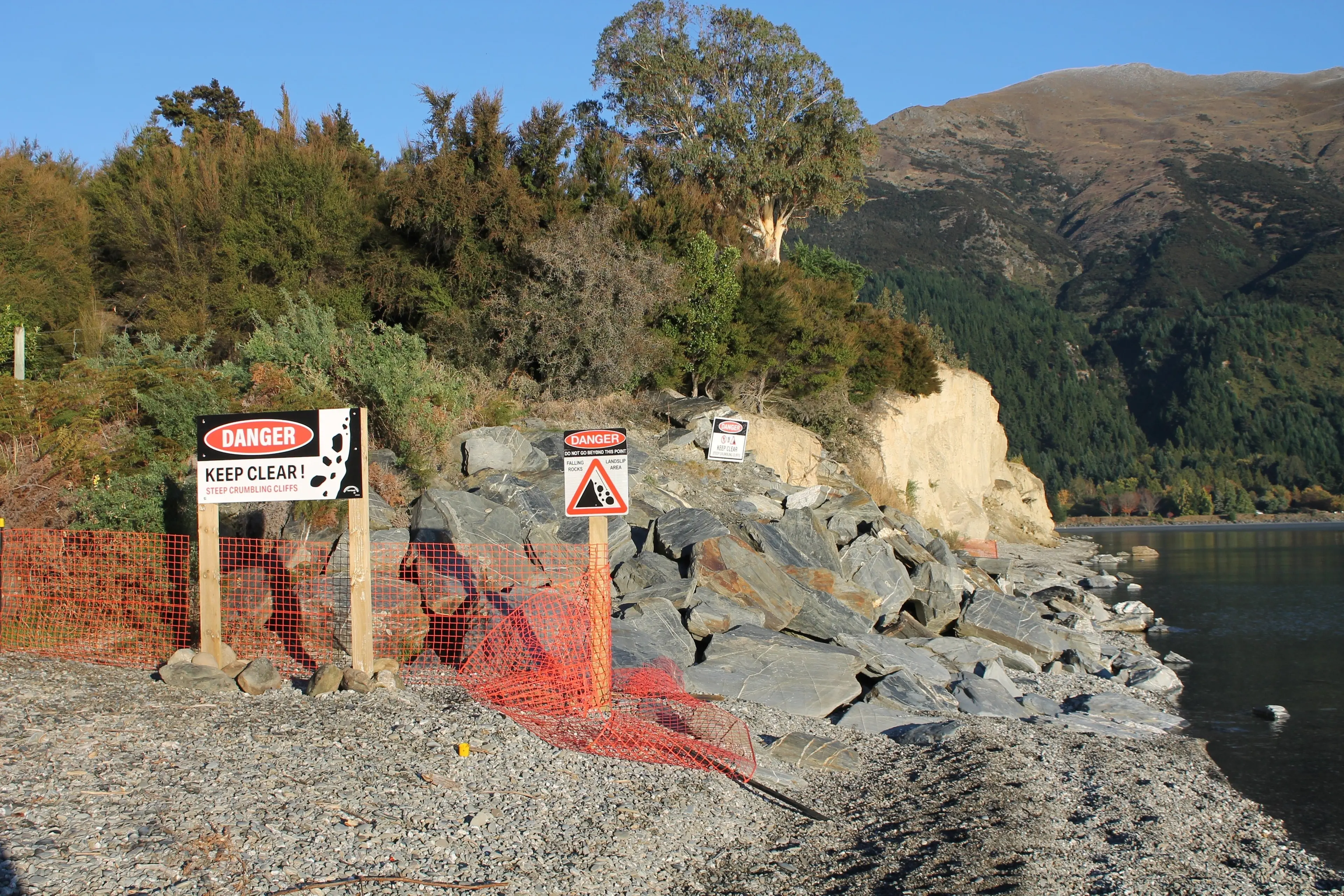 Signage in front the Flora Dora Cliffs at Lake Hawea indicating that the cliffs have become a danger to the public. Photo taken by Ruairi O\\'Shea on 22 April 2026.