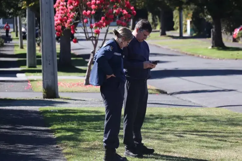 Police officers making inquiries into the incident on High St, Rotorua, on Tuesday. Photo: NZME