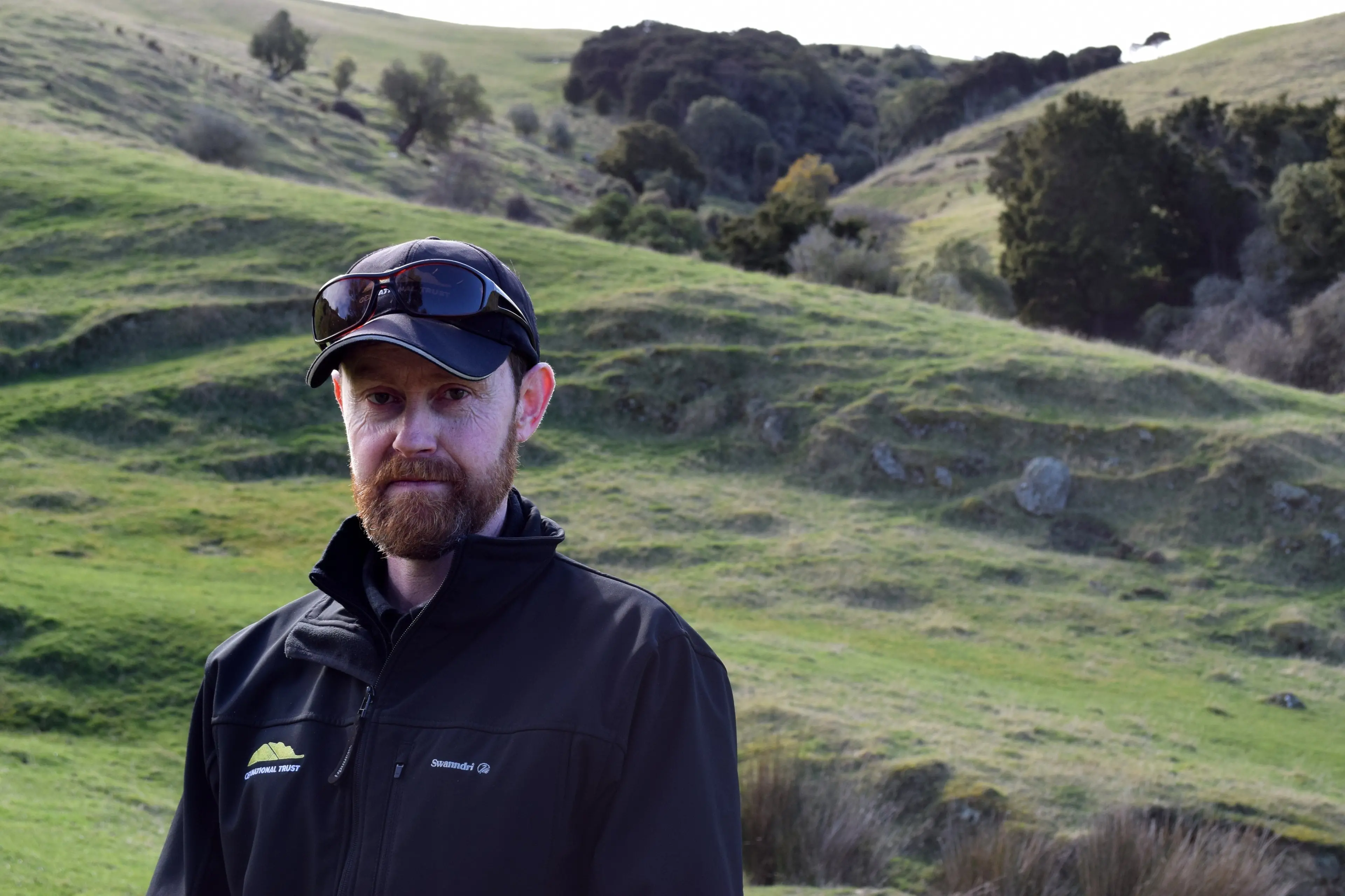Queen Elizabeth II National Trust Coastal Otago and South regional representative Morgan Trotter, of Warrington, spoke about the work of the trust, current challenges and how QEII covenants can be used for on farm biodiversity protection, including the one in the gully behind him, at an East Otago Catchment Group field day in Goodwood last week. Photo: Shawn McAvinue