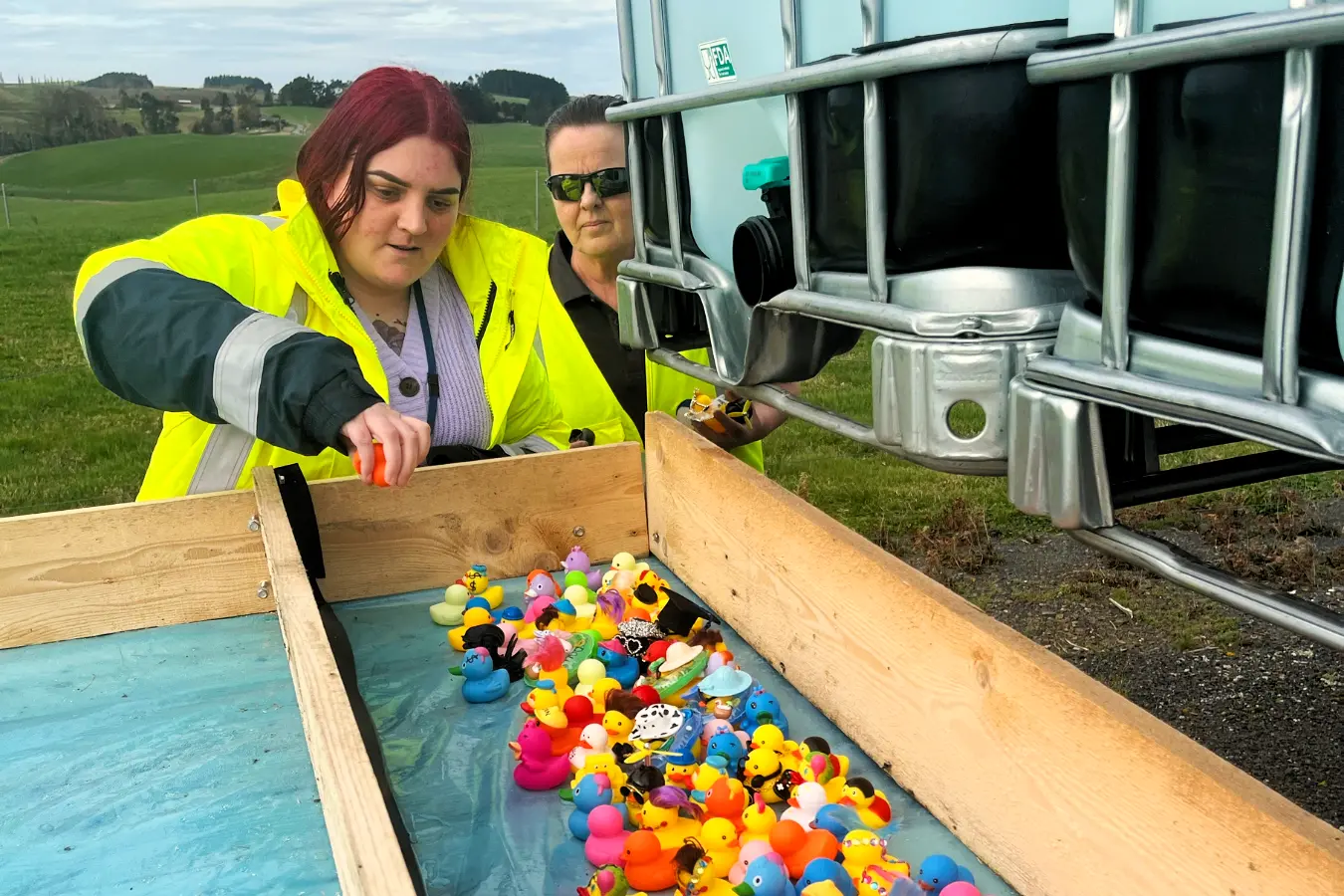 Danone Balclutha dryer line lead Crysta Ratcliff (left) loads up her duck for the plant\\'s fundraising duck race last week, while operations department manager Sarah Cunningham looks on. Photo: Supplied