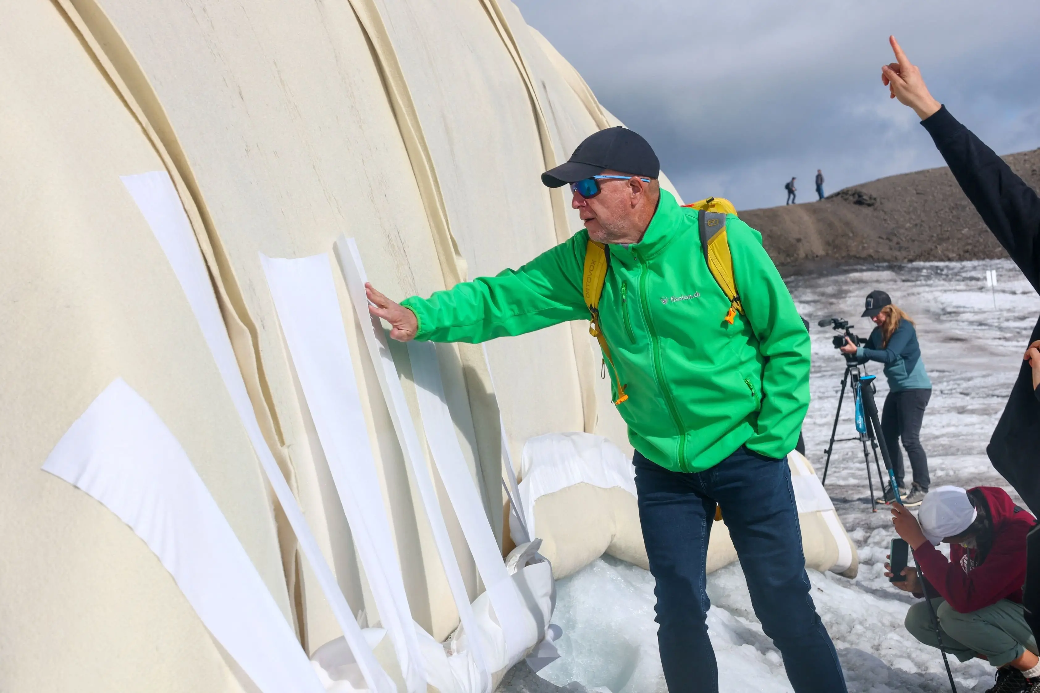 Niklaus Sagesser, the weaver who made the sheep wool covers, checks them at a snow protection test site in Les Diablerets, Switzerland. The project tested wool coverings on the Tsanfleuron Glacier to help slow glacier melt. Photo: Reuters