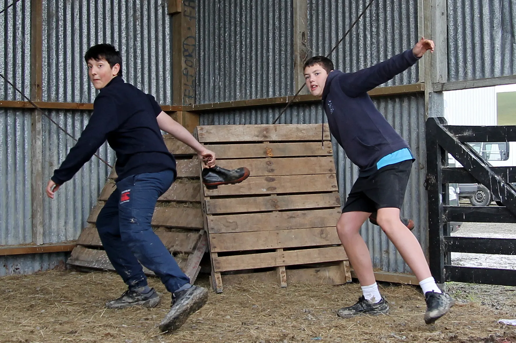 Blue Mountain College\\'s David Daianu (left) and Mitchell Stiven, both 12, get into the swing of the gumboot throw at SIT Telford College, Balclutha. Photo: Nick Brook