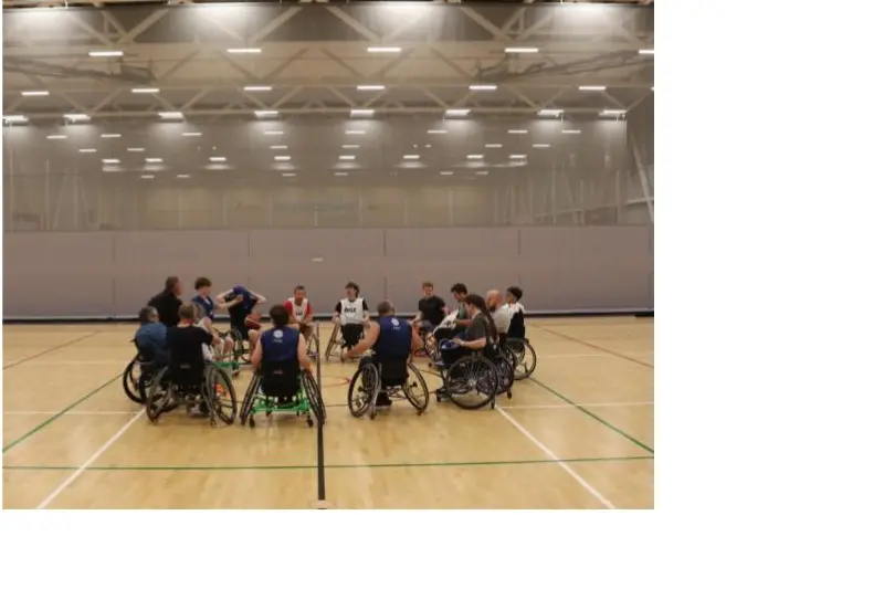 Time-out . . . The Canterbury Rollars wheelchair squad huddles in the middle of the court at MainPower Stadium in Rangiora, mid-way through a training game. Photo: Daisy Vavasour