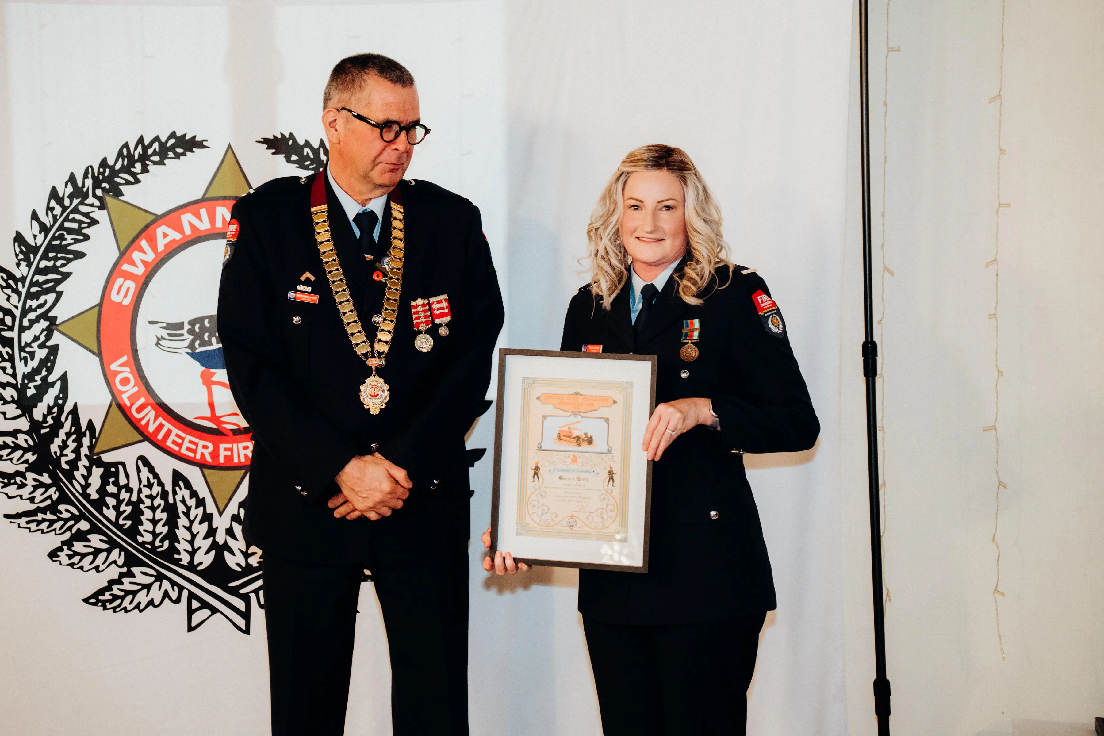 Walking for Sarah . . . Sarah receiving an award at the recent Swannanoa Fire Brigades Awards evening. Photo; Niall Featerstone