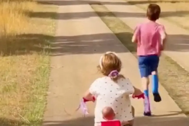 Prince Archie runs ahead of his sister, Princess Lilibet, at an unknown location in this image taken from video released this month. Photo: Meghan, Duchess of Sussex via Instagram/Handout via Reuters