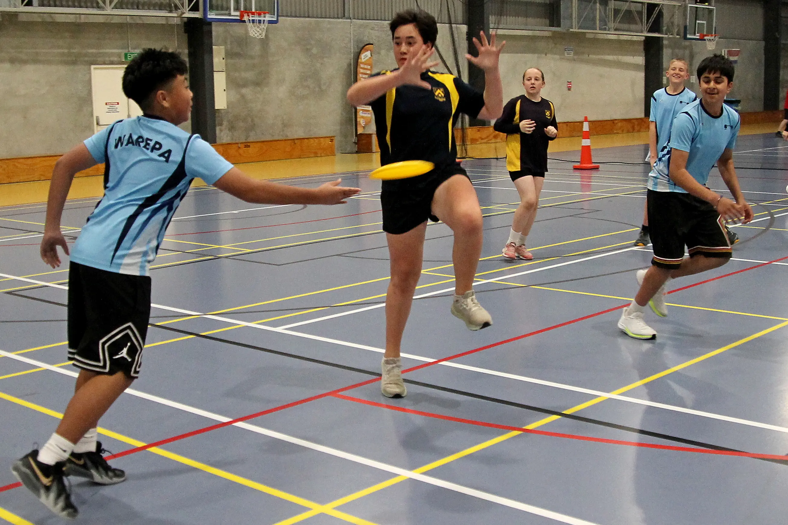 Warepa\\u2019s Francis Reyes spins the disc past (from left) Lawrence Area School\\u2019s Te Manawa Taumata and Leilani Cook towards Hadlee Gordon and Parambir Minhas, all 12. Photo: Nick Brook
