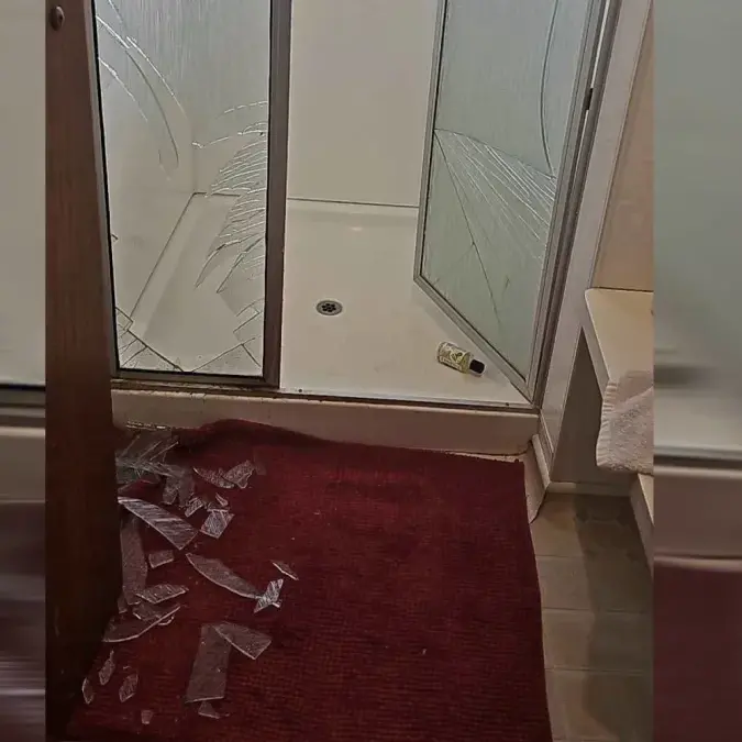 Hot shower warning as woman falls through glass after fainting with flu