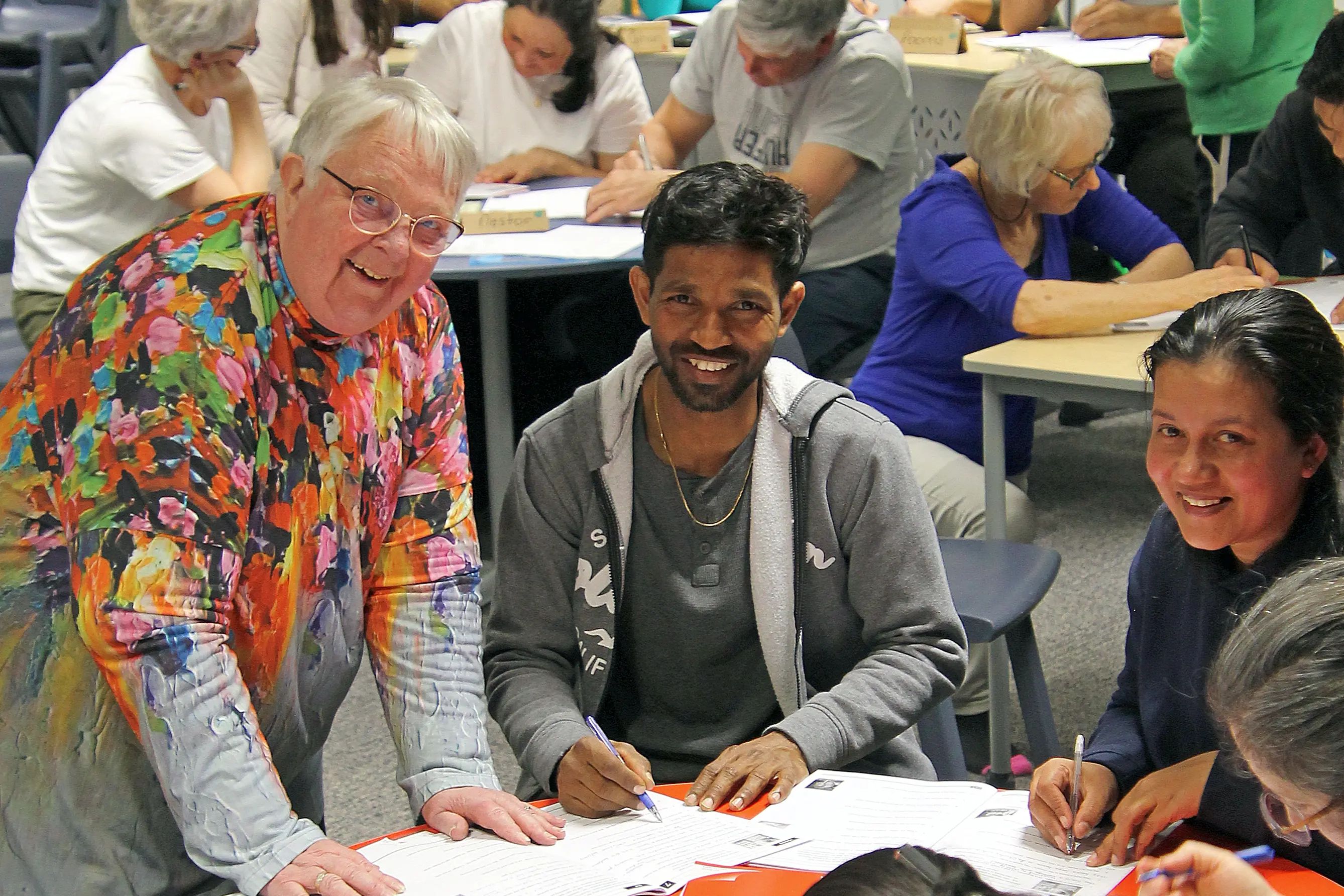 Teacher Gloria McHutchon, left, assists Sri Lankan students Manoj Maddumage and wife Lasitha Ragamuni at a free English language class in Clydevale, last week. Photo: Nick Brook