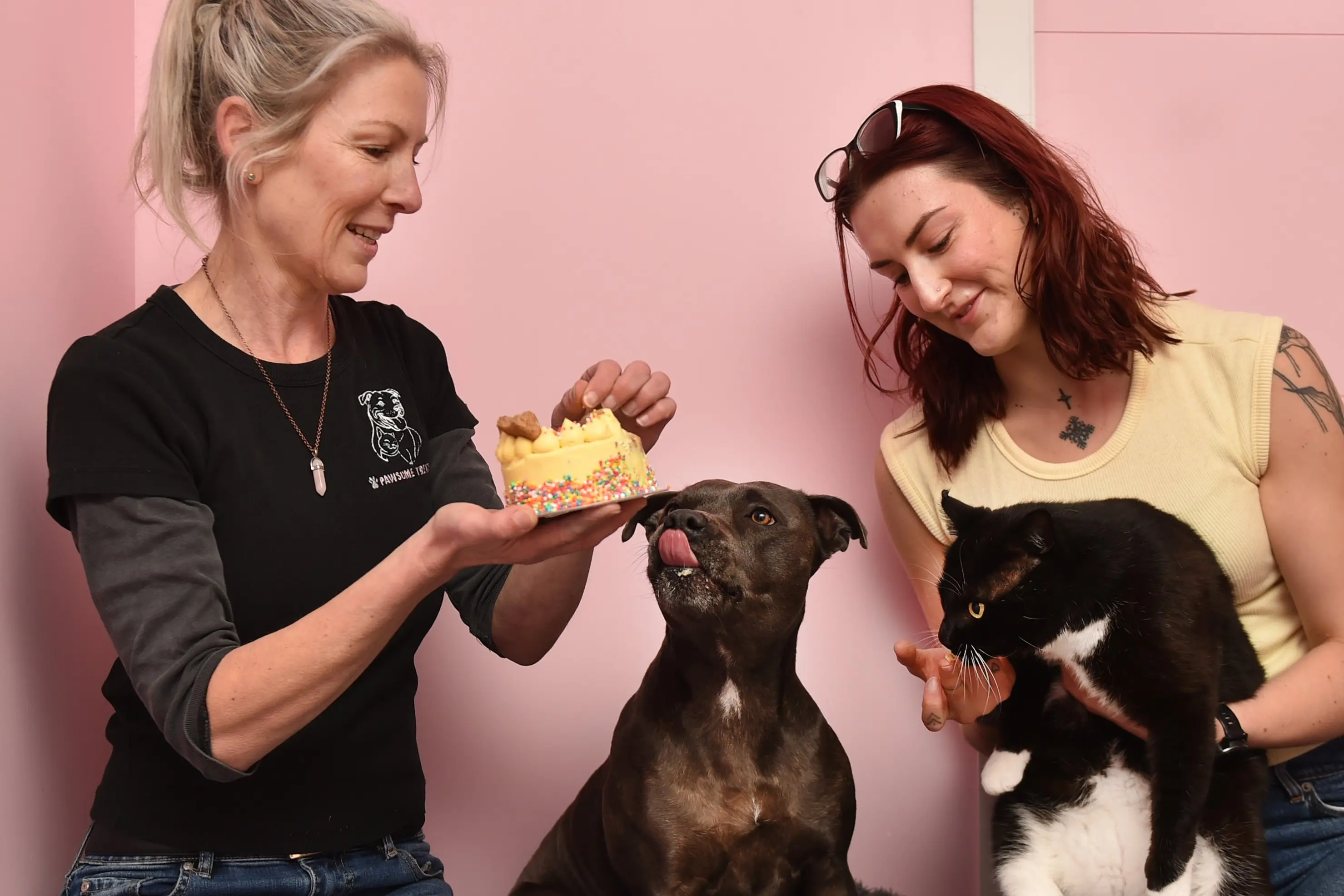 Pawsome Treats owner Toni (left) and her daughter Mikaela King with their pets Ruby the dog and Turbo the cat. Photo: Gregor Richardson