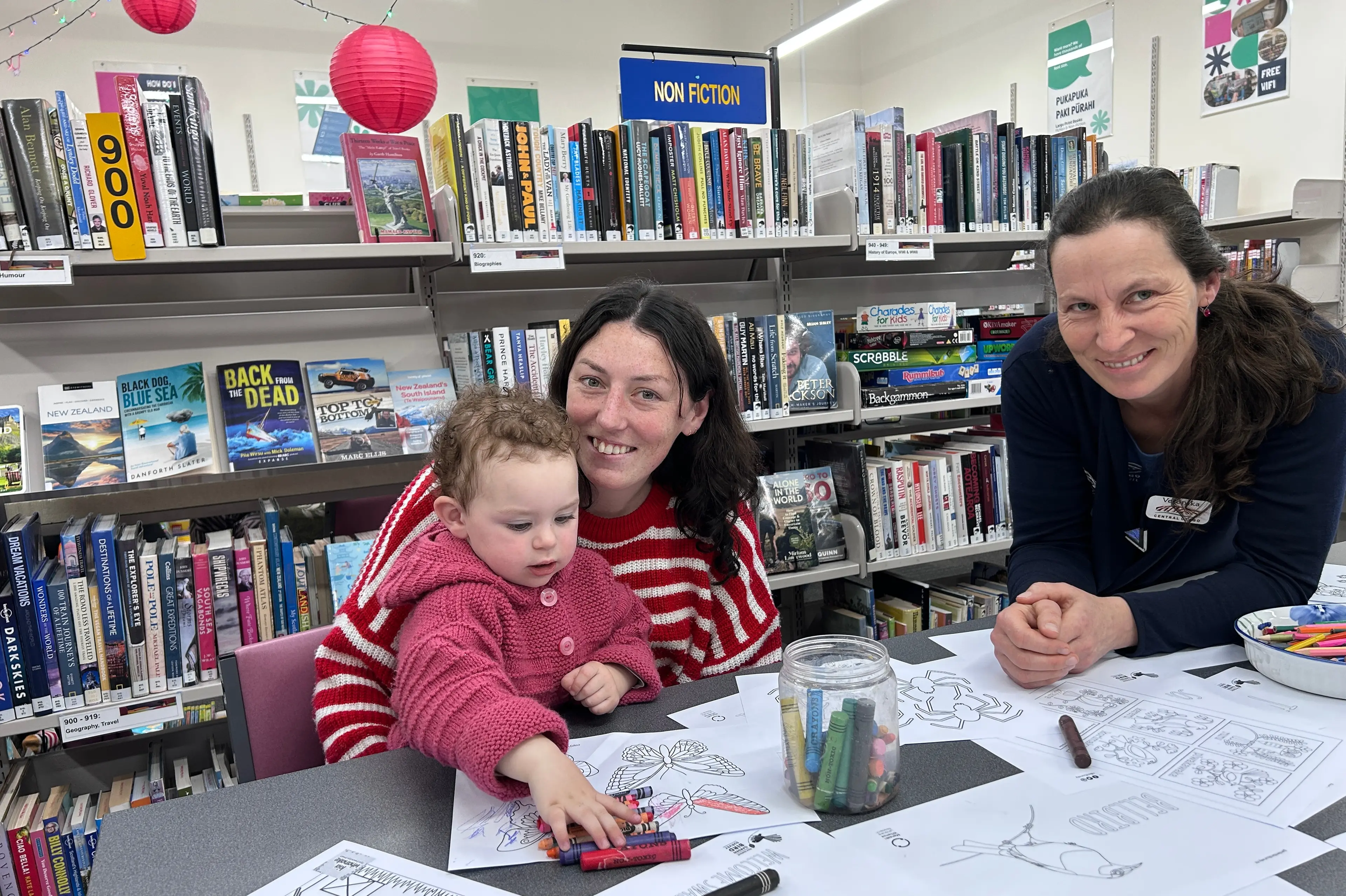 Enjoying colouring and learning the Te Reo words for the pictures are Ellie Neal, 2, and her mum Victoria de Filiepi. Helpiing out is Roxburgh Service Centre customer service officer Veronika Sim. Photo: Julie Asher
