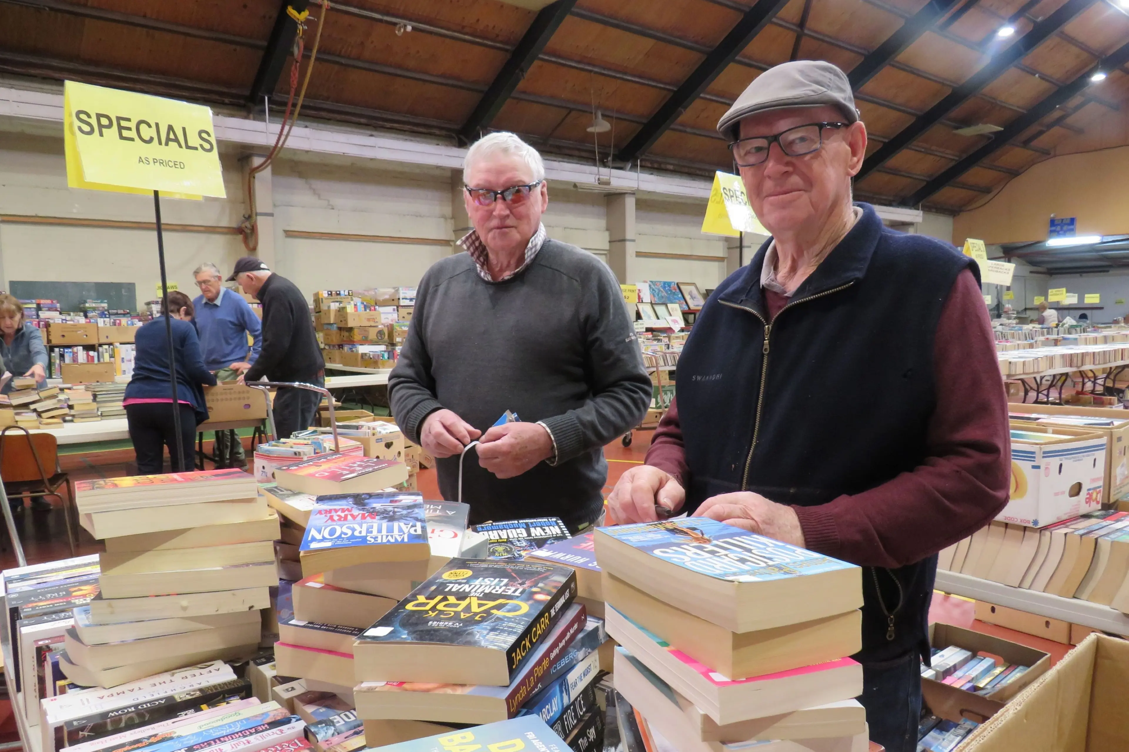 Rotary Club of Ashburton Bookarama convenor David Mead (right) with fellow Rotarian Murray Moorhead pricing books. Photo: Dellwyn Moylan