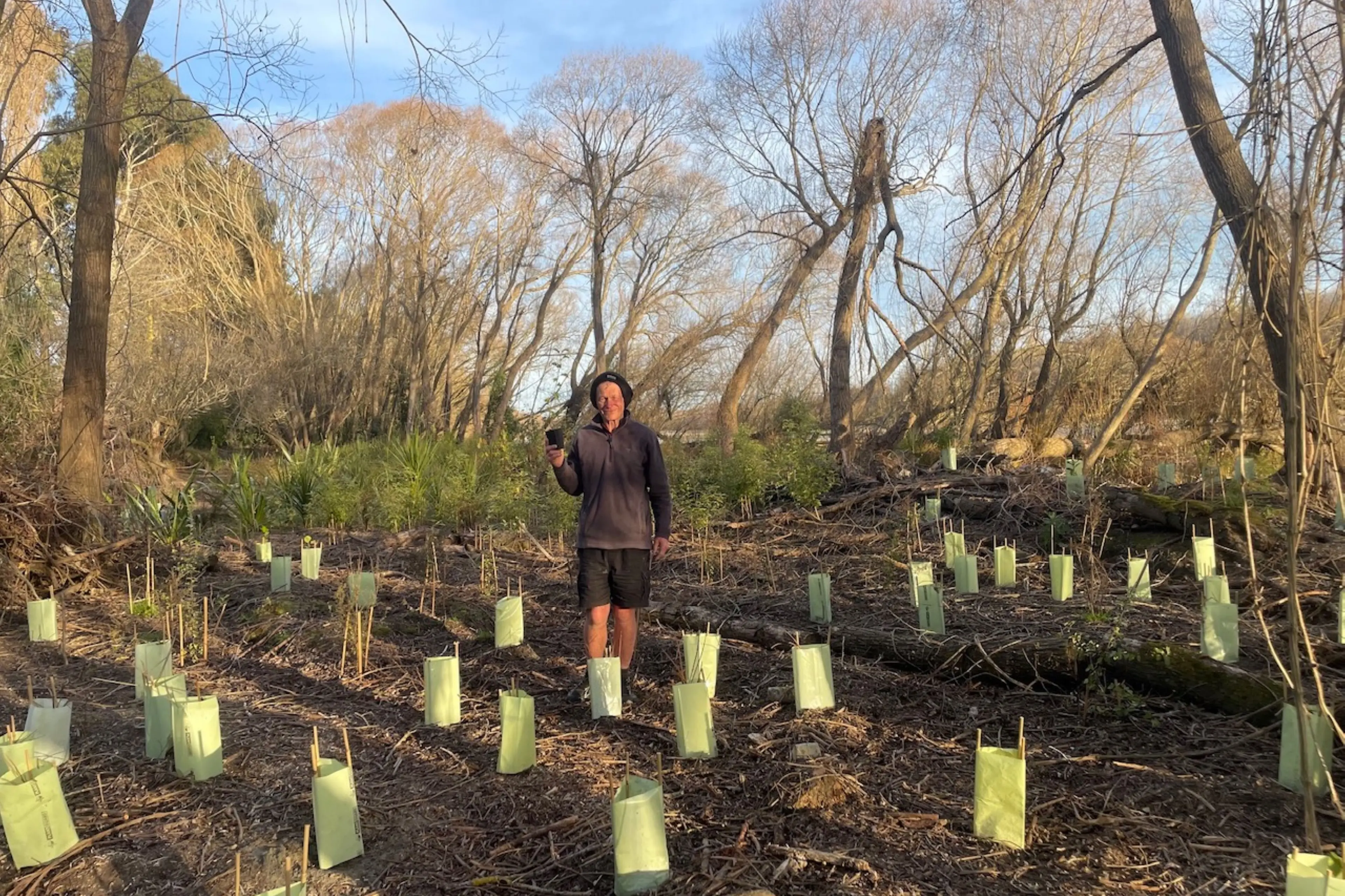 Ross Hawthorne with plant number 10,000 along the Ashburton/Hakatere River trail. Photo: Supplied.