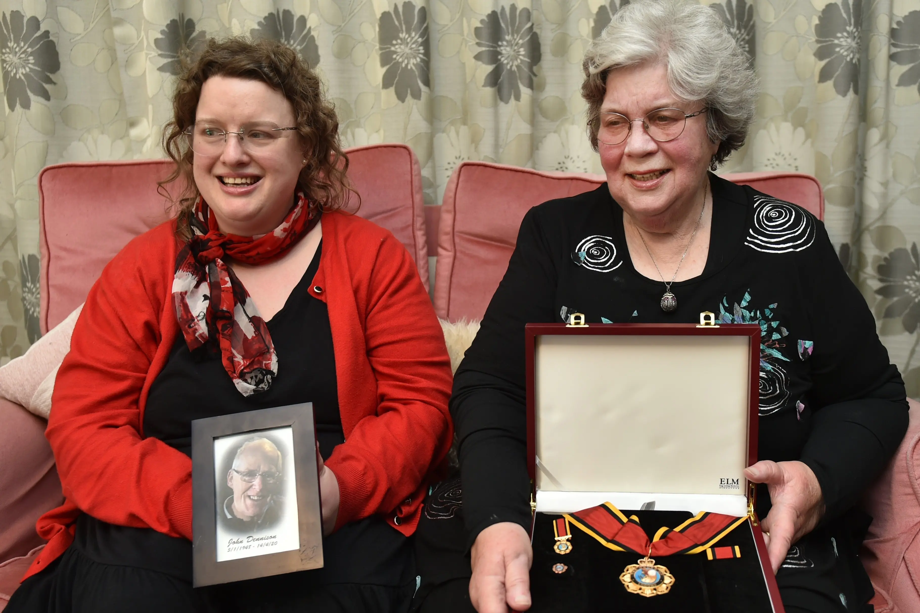 John Dennison\\'s daughter Sarah, left, and his wife Ann Dennison holding his Officer of the Order of Logohu award from Papua New Guinea. Photo: Gregor Richardson