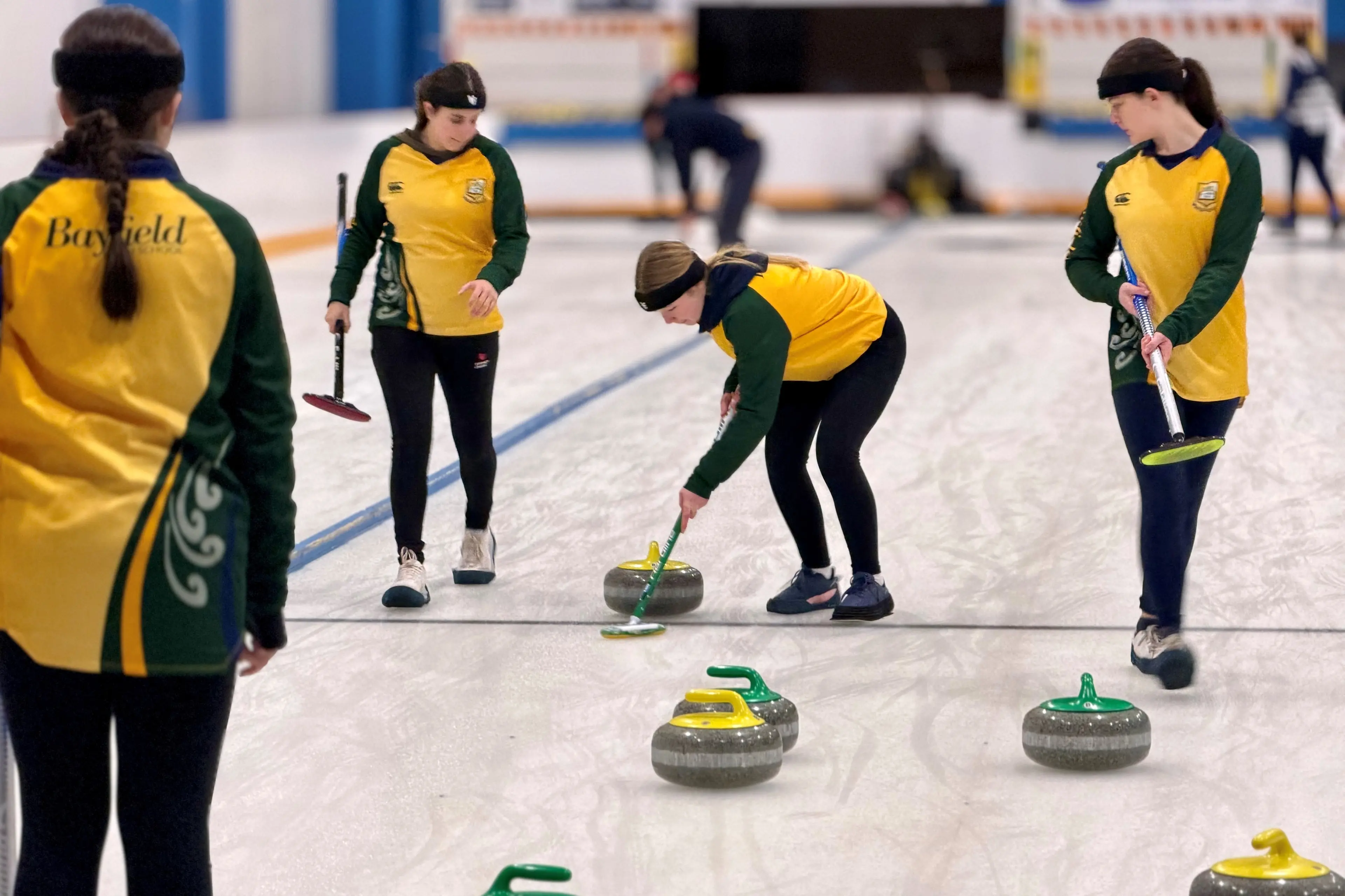 Bayfield High School curlers compete at the Otago secondary schools championships. Curling showcases teamwork at its best with players calling the line, sweeping together and supporting each other to put each stone exactly where it needs to go. Whether sweeping hard to guide a stone towards the button or celebrating a perfectly executed takeout shot, success on the ice is a shared team achievement. From left are Madeline Hage-Sleiman (back to camera), Isla Stiles, Ella Garbett and Gemma Pickering. Photo: Nigel Pacey/Maniototo Area School
