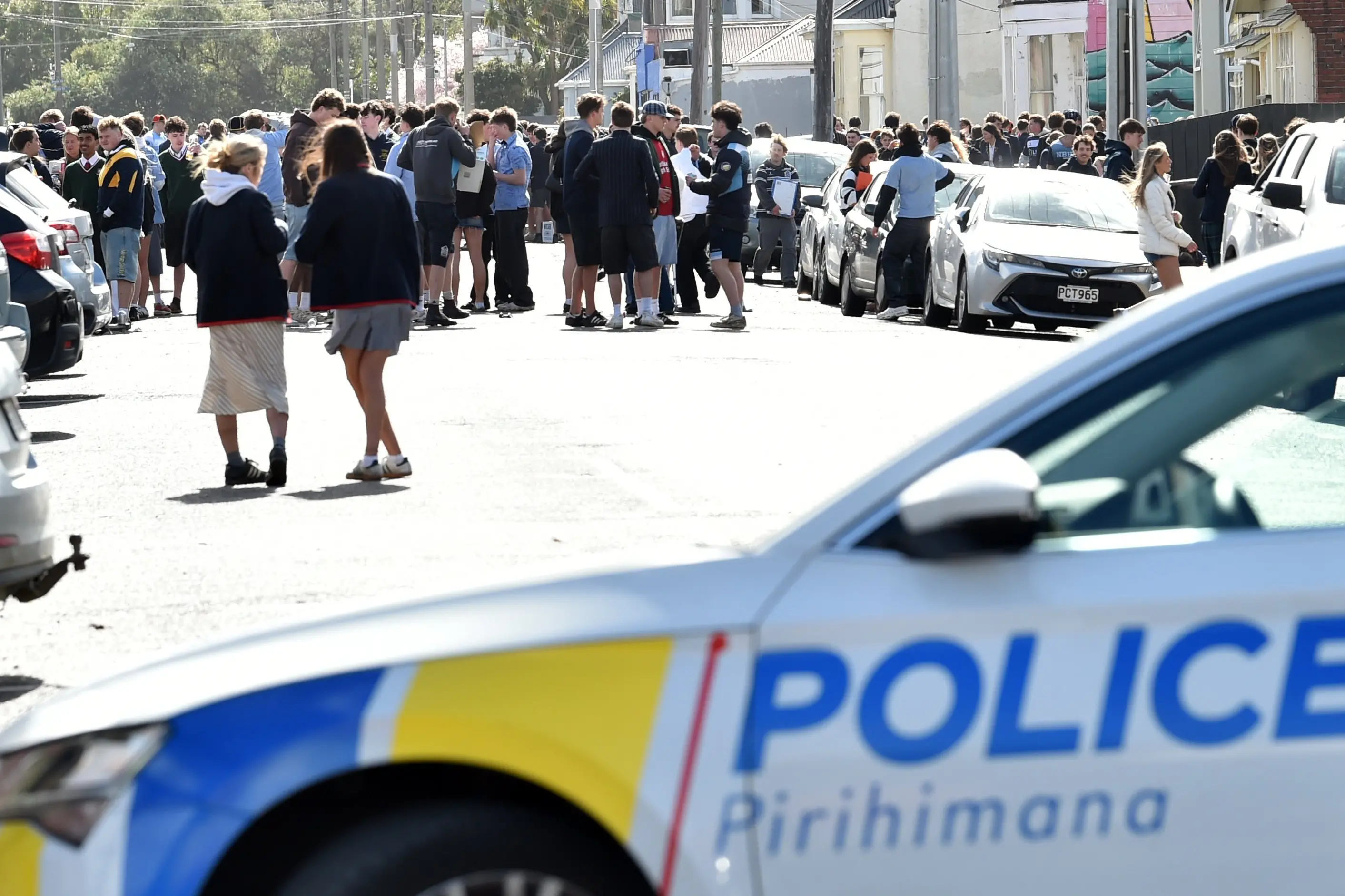 Police kept an eye on students at the Castle St party on Sunday morning. Photo: Peter McIntosh/ODT