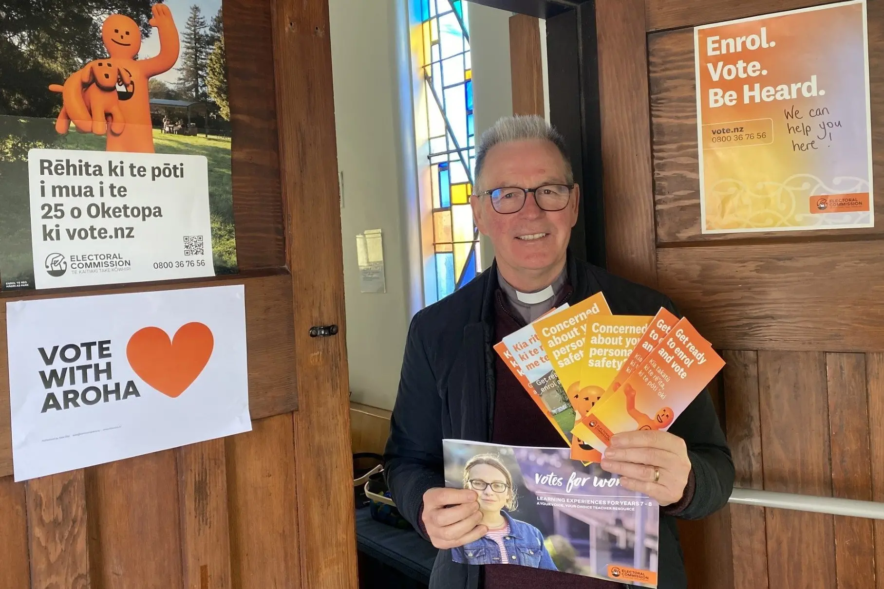 St Michael & All Angels Church Reverend Michael Holdaway is pictured with an array of election information, as the church gears up to host an election enrolment event this Sunday, September 27. Photo: Brenda Harwood